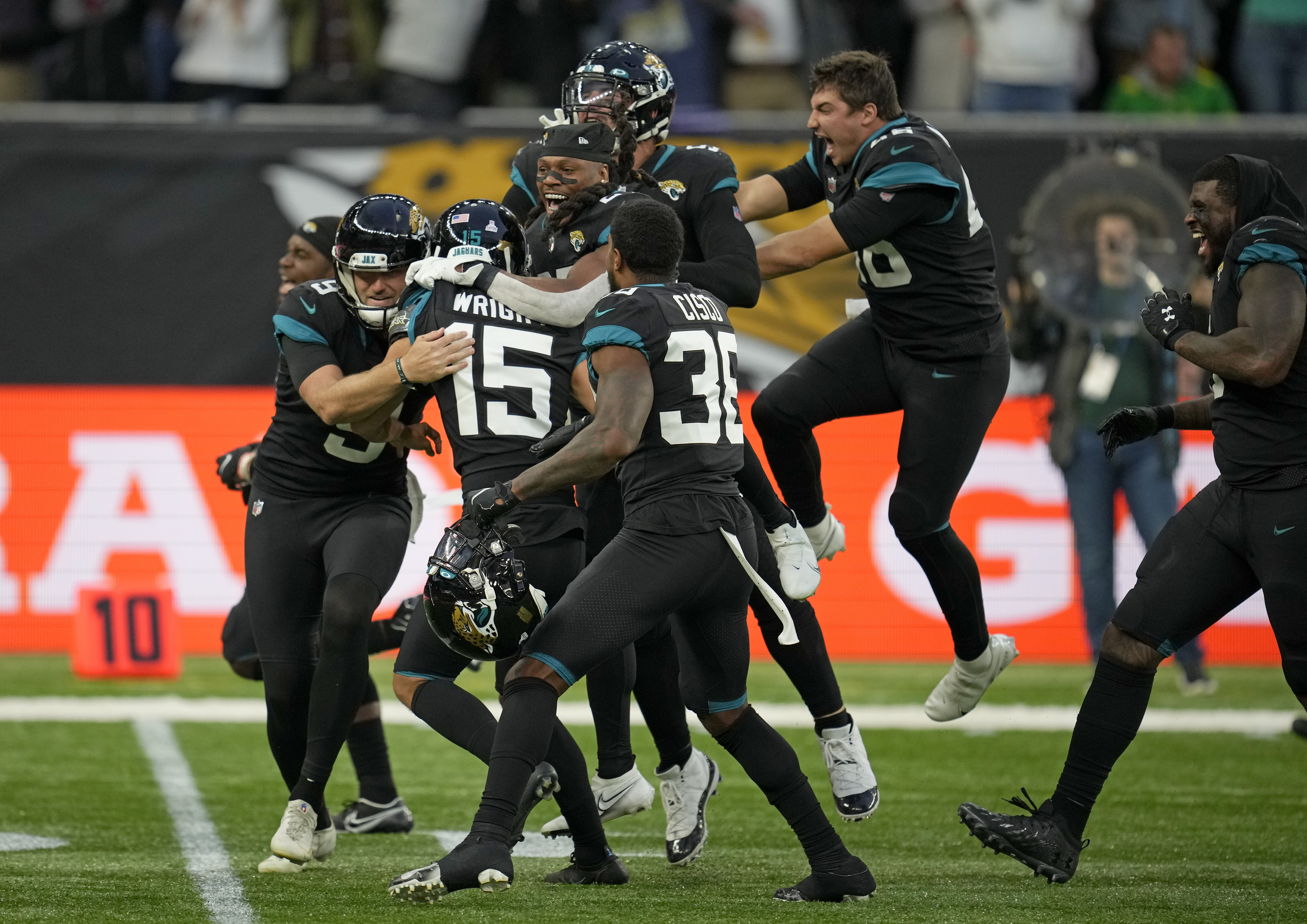 FILE - Jacksonville Jaguars quarterback Trevor Lawrence (16) runs onto the  field for an NFL football game between the Miami Dolphins and the Jaguars  at the Tottenham Hotspur stadium in London on