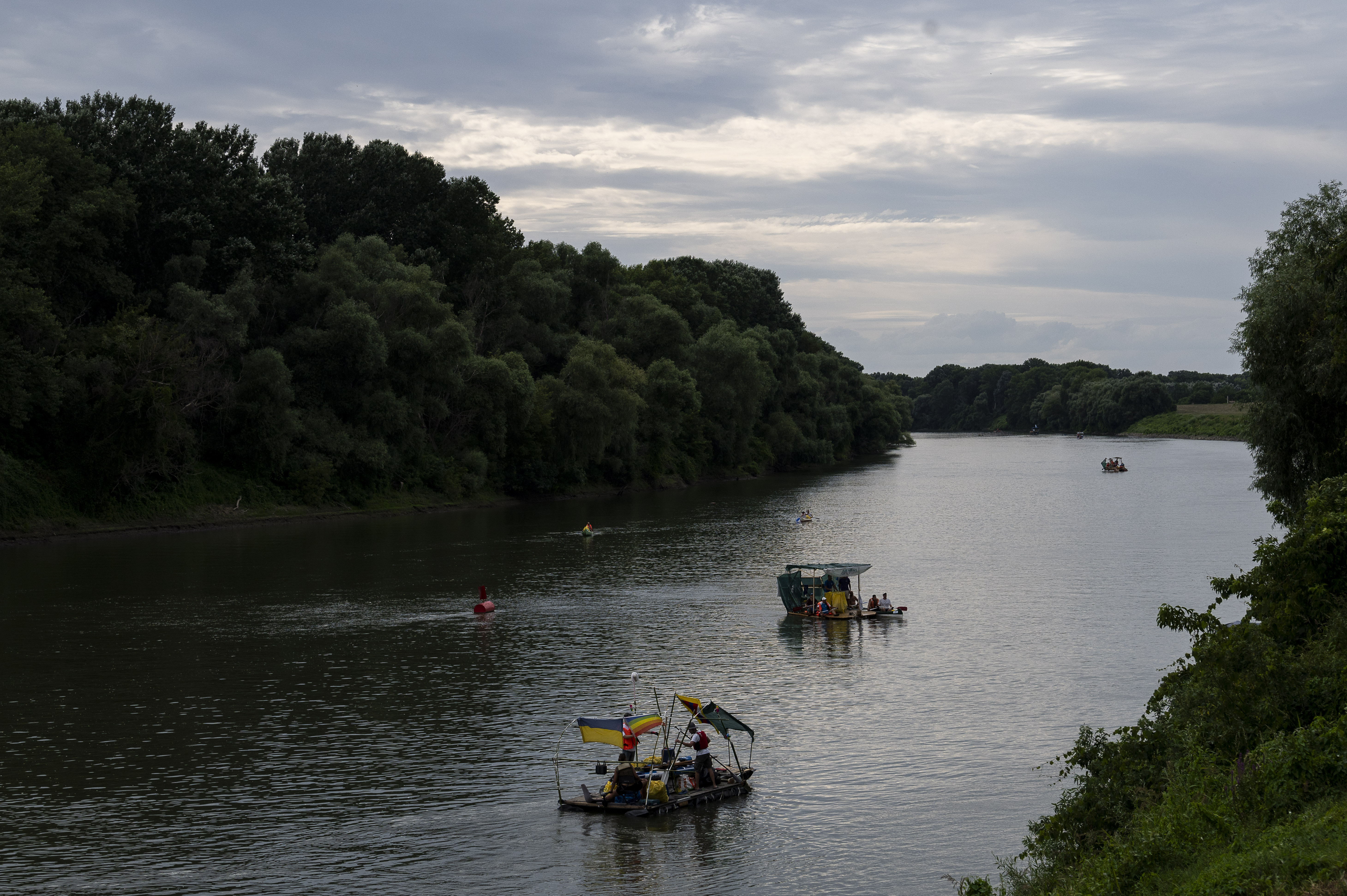 Volunteers offload their boat after it overloaded with collection bags  while attending the Plastic Cup event near Tiszaroff, Hungary, on Aug. 2,  2023. Since its start in 2013, participants in the annual