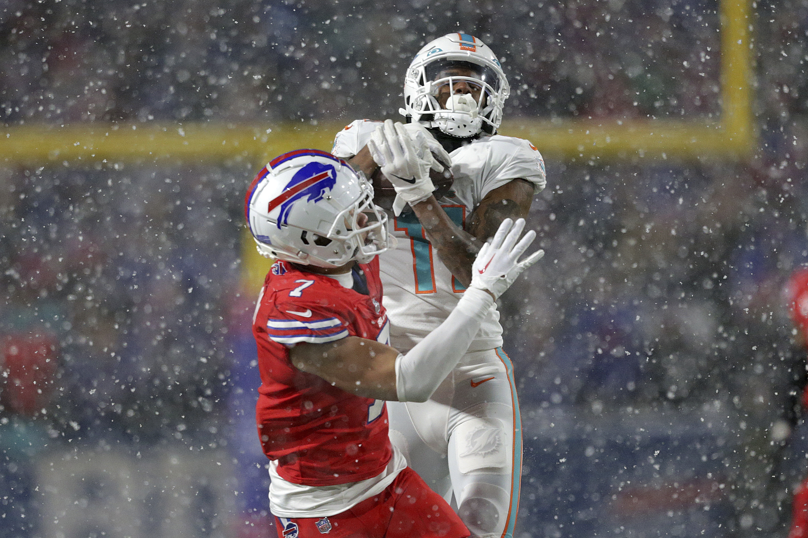 Miami Dolphins wide receiver Jaylen Waddle (17) catches a pass Buffalo  Bills cornerback Tre'Davious White (27) during second quarter of an NFL  football game at Highmark Stadium on Saturday, Dec. 17, 2022