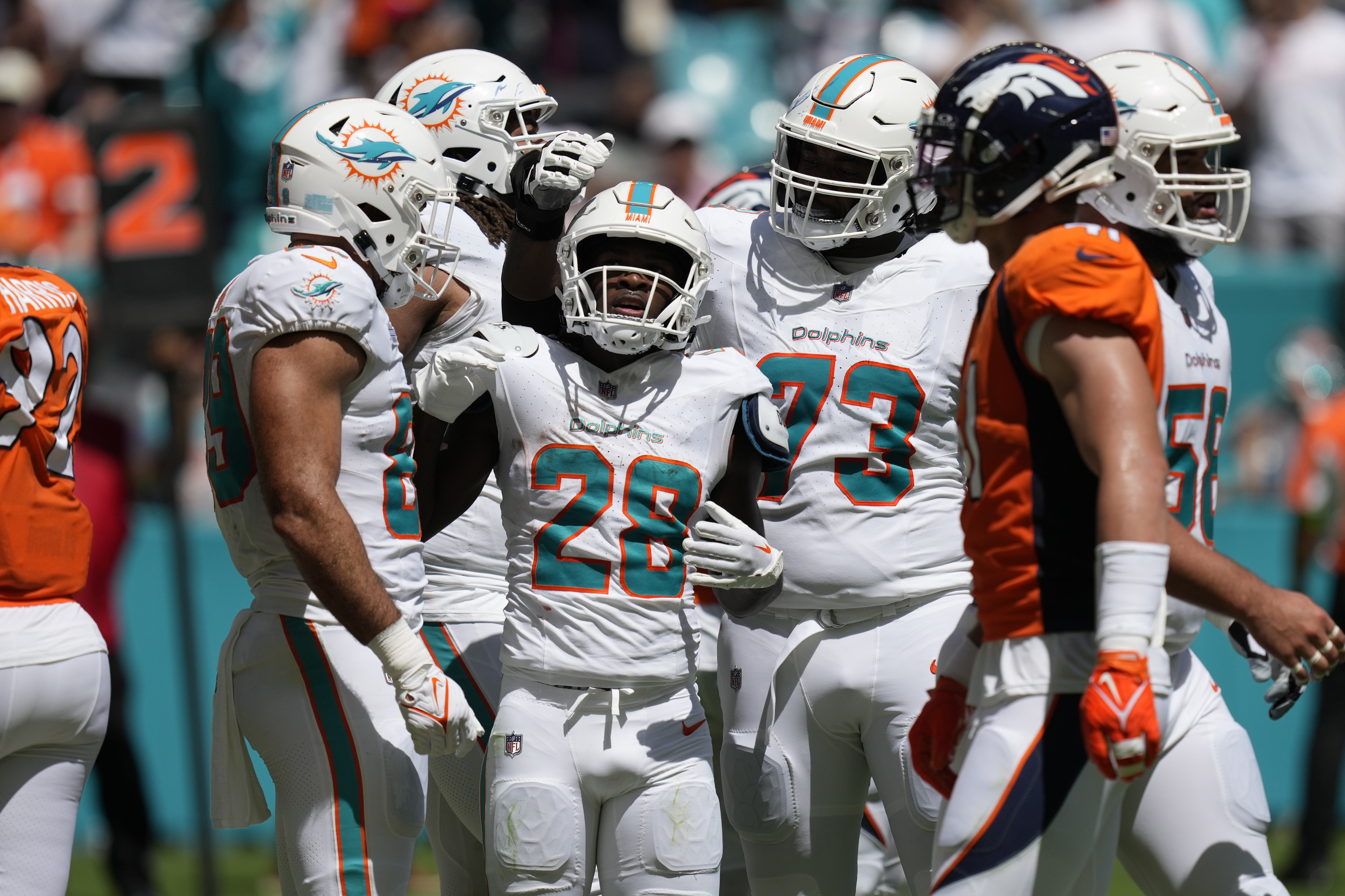 Miami Dolphins running back Raheem Mostert (31) celebrates with teammates  after scoring a touchdown against the Denver Broncos during the second  quarter of an NFL football game at Hard Rock Stadium, Sunday