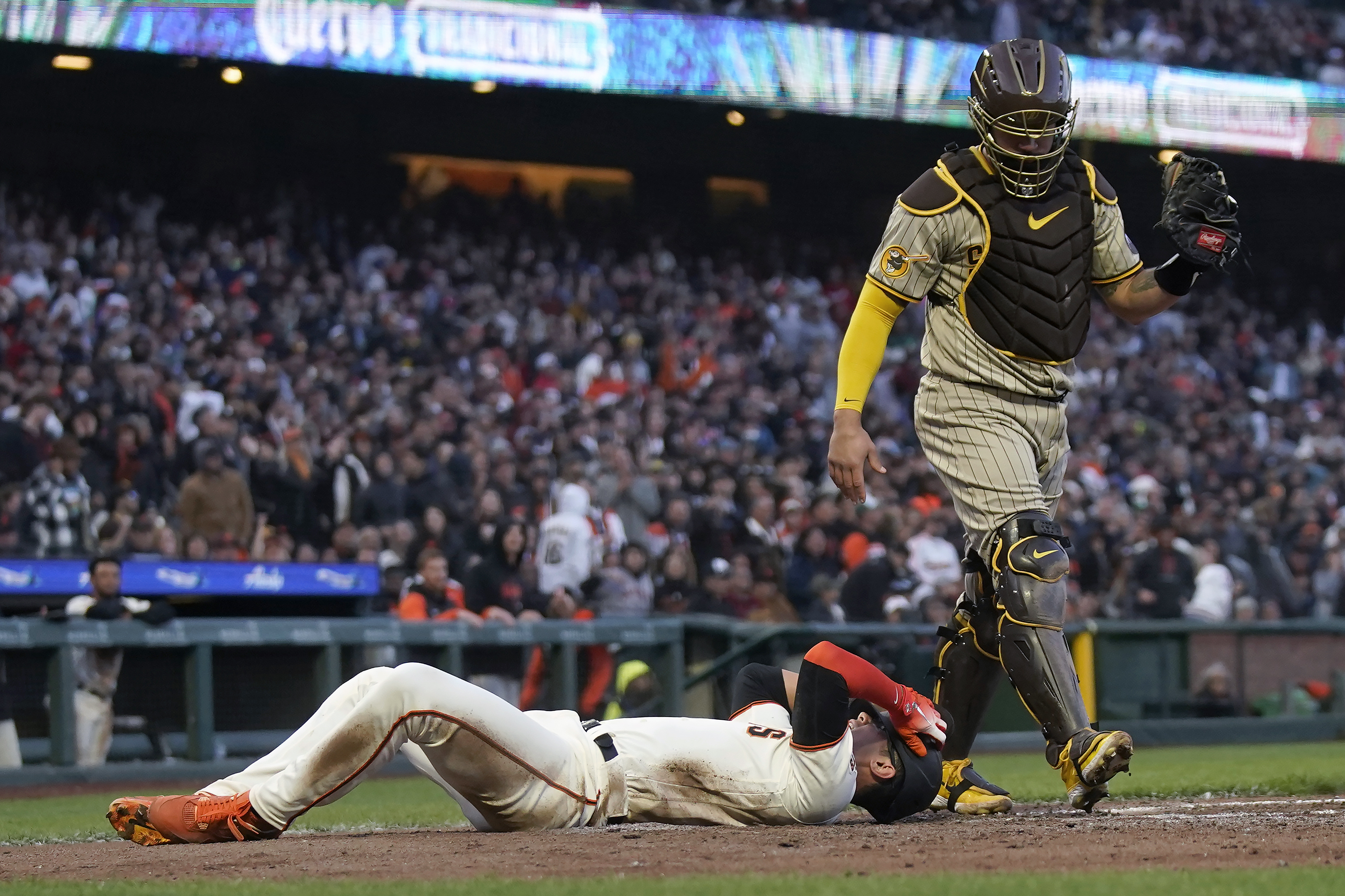 San Diego Padres right fielder Travis Jankowski leaps as a fan