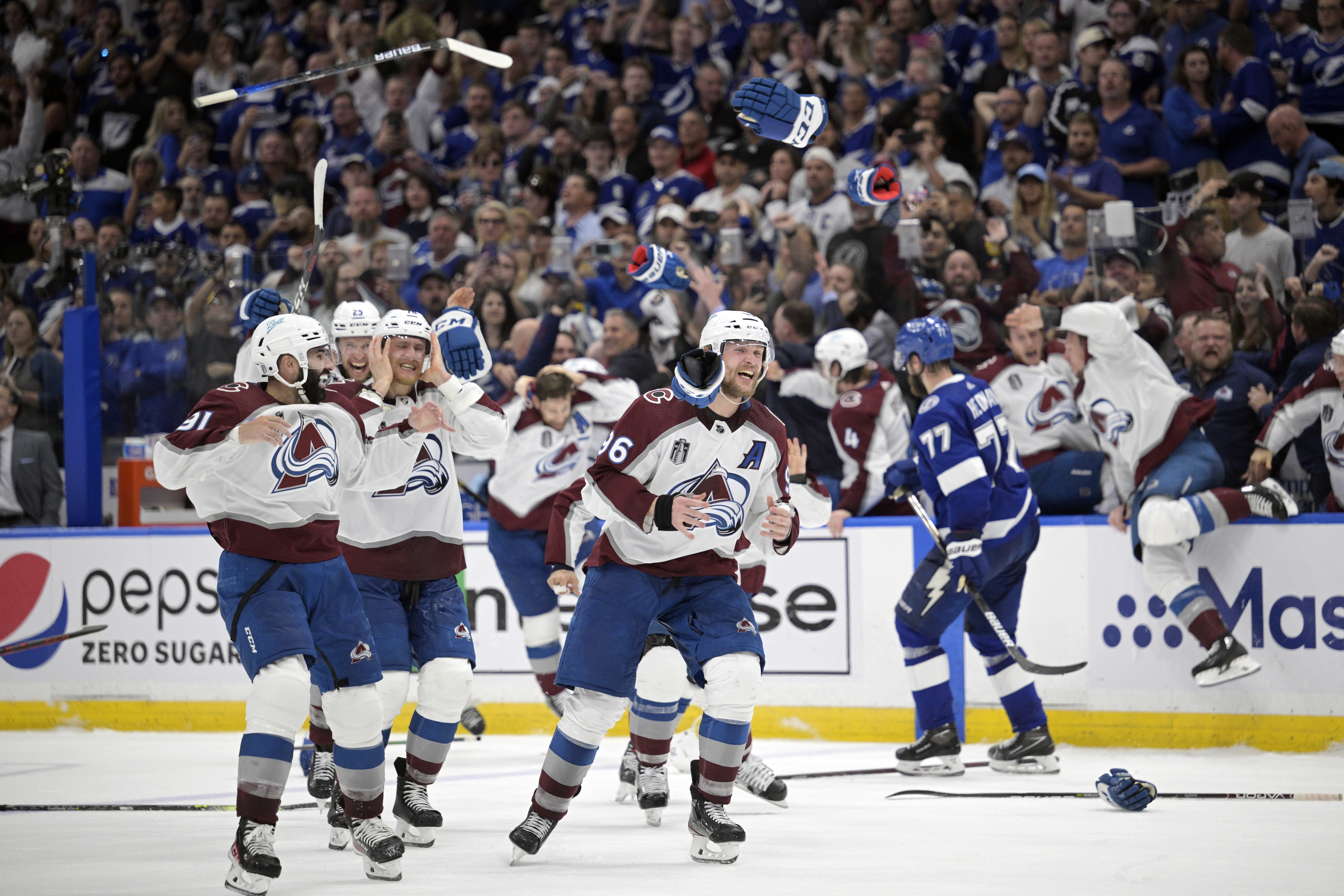 After parade, work begins for Avs in bid to repeat as champs