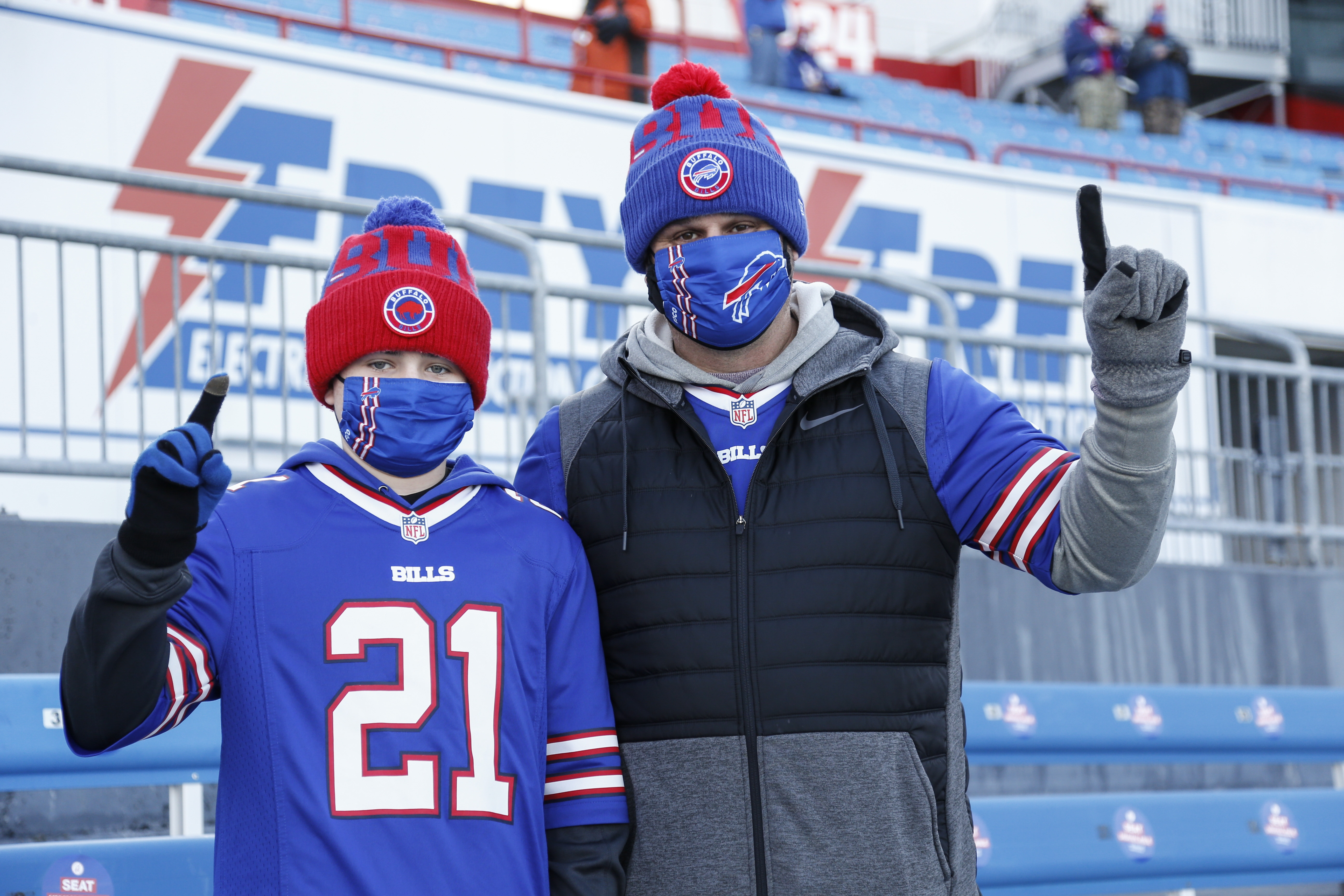 Fans cheer as teams warm up before an NFL wild-card football game