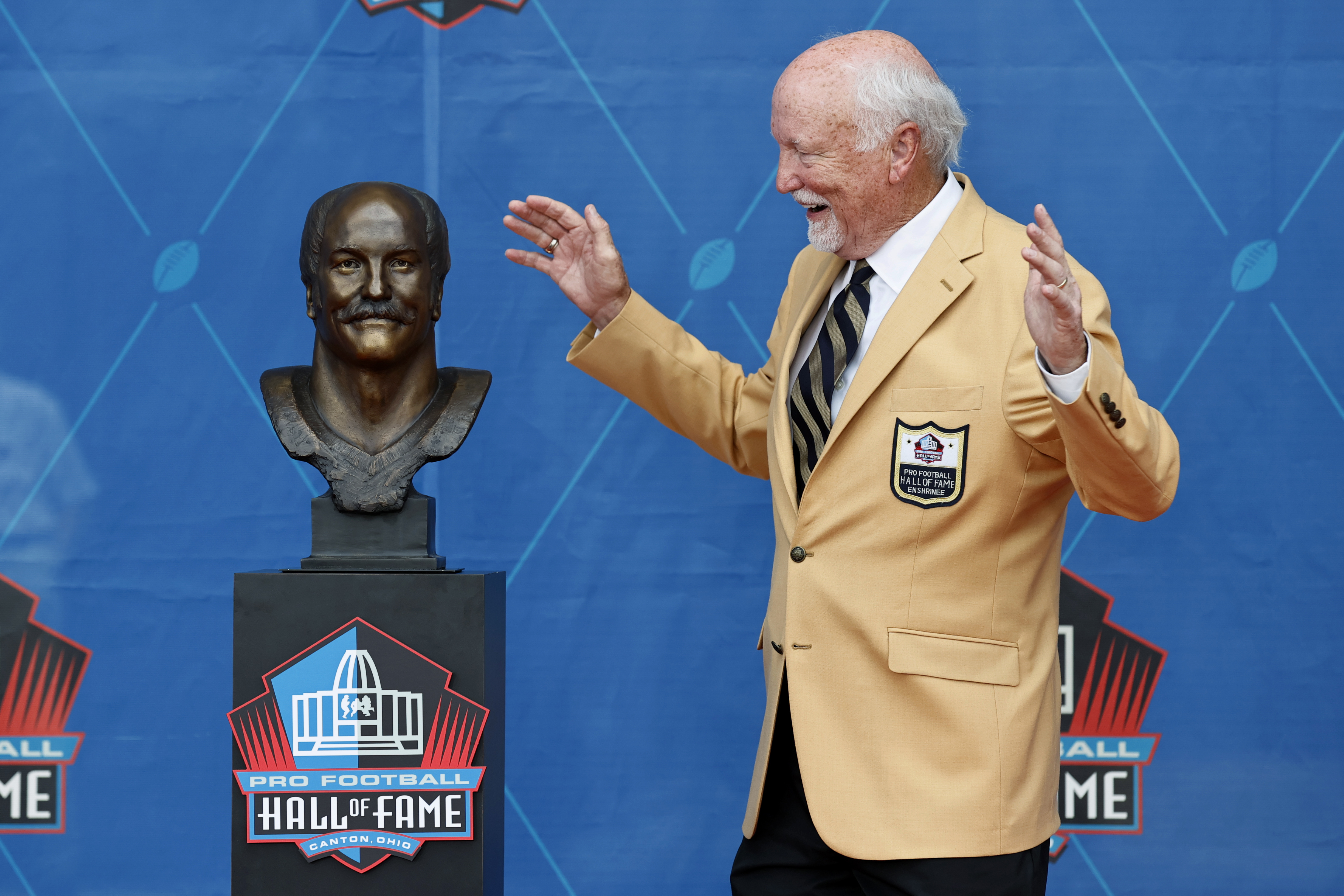 Dan Marino with his bust after his induction into the Pro Football