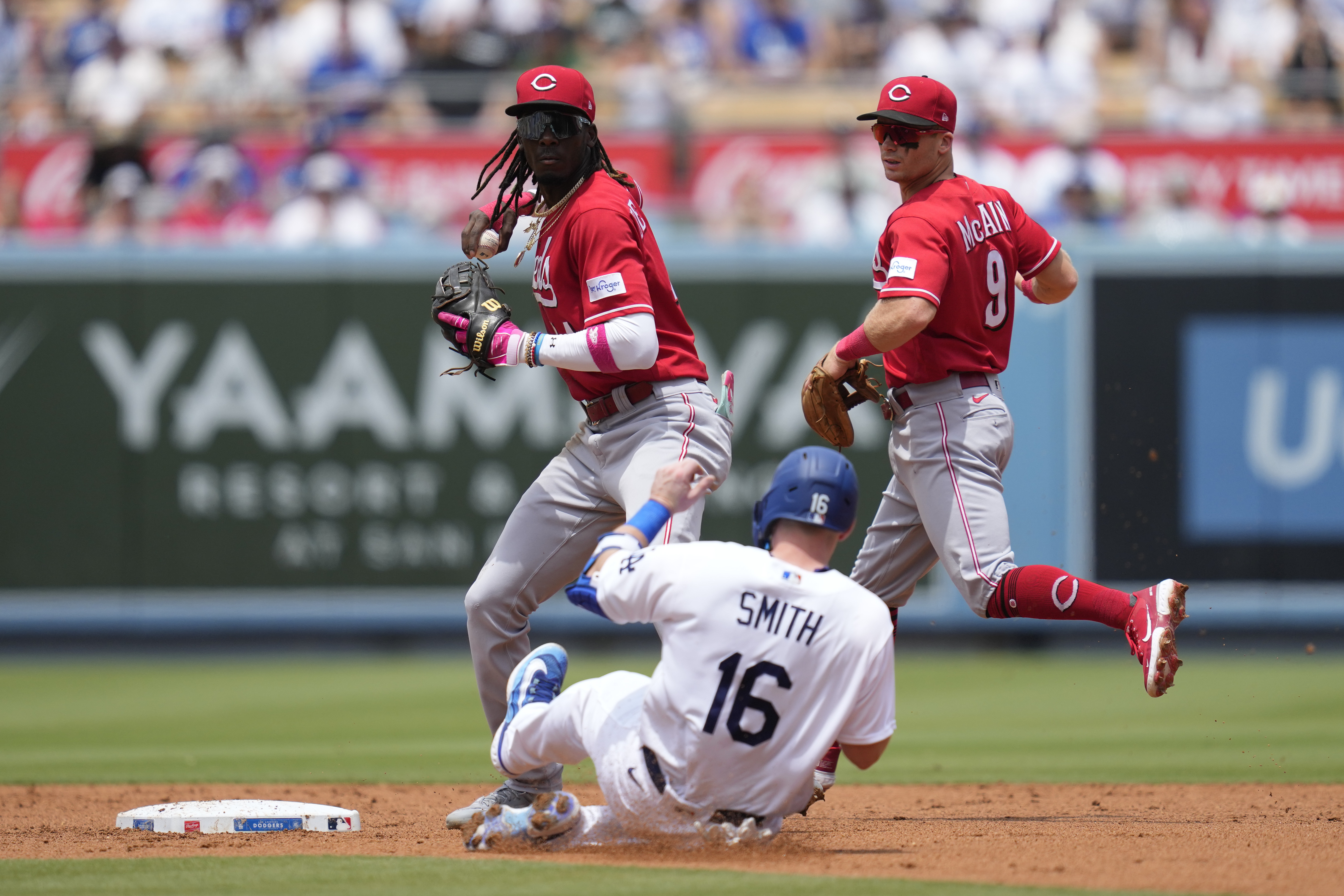 Cincinnati Reds' Spencer Steer (7) places a viking helmet on the head of  Elly De La Cruz (44) after Cruz hit a home run during the second inning of  a baseball game