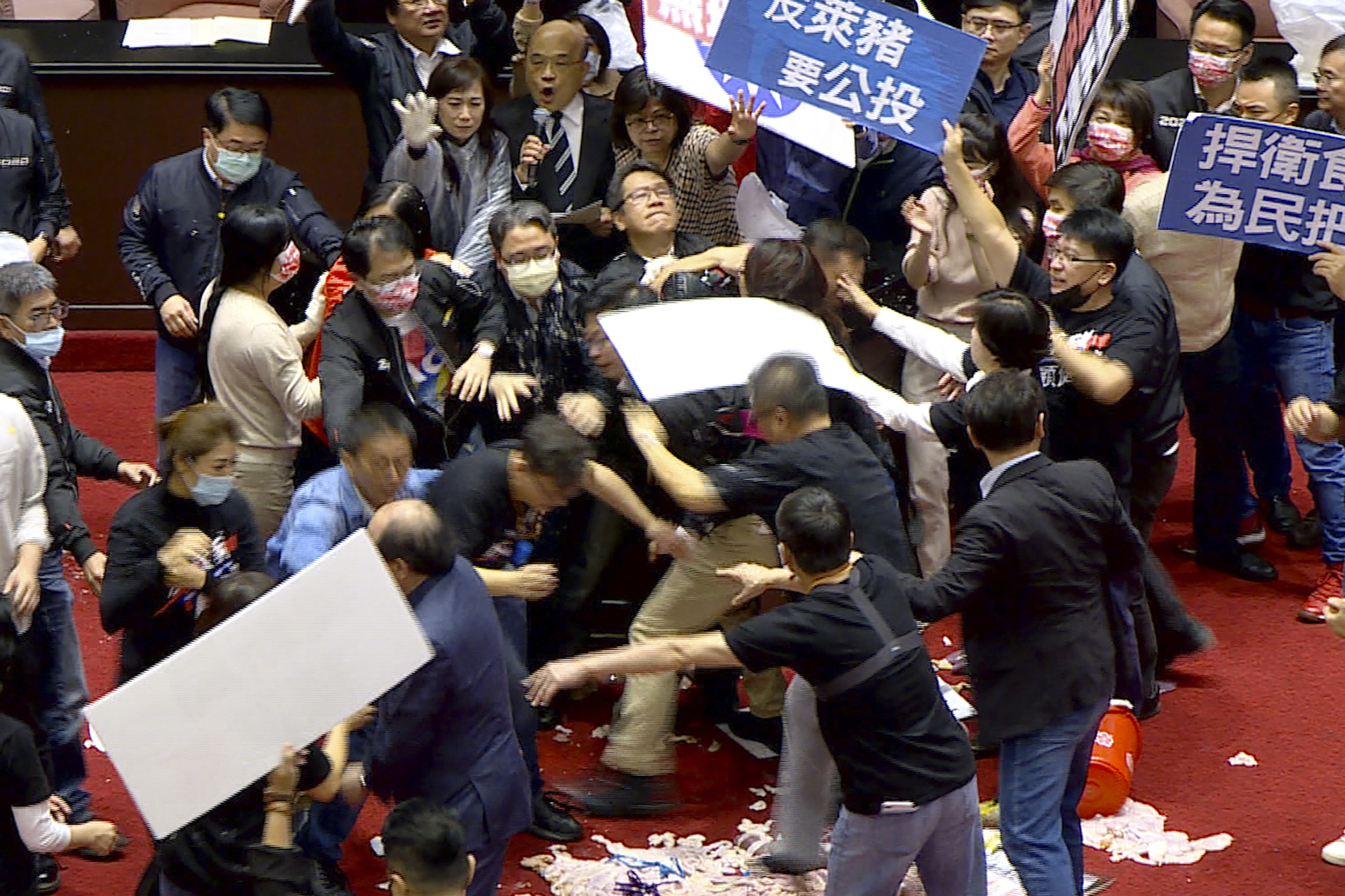 Lawmakers throw pig guts, punches on Taiwan parliament floor