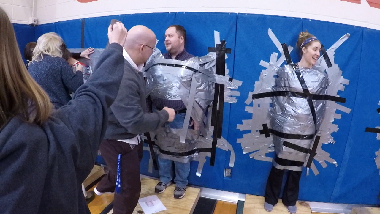 Students duct tape teachers to the wall for cancer research fund