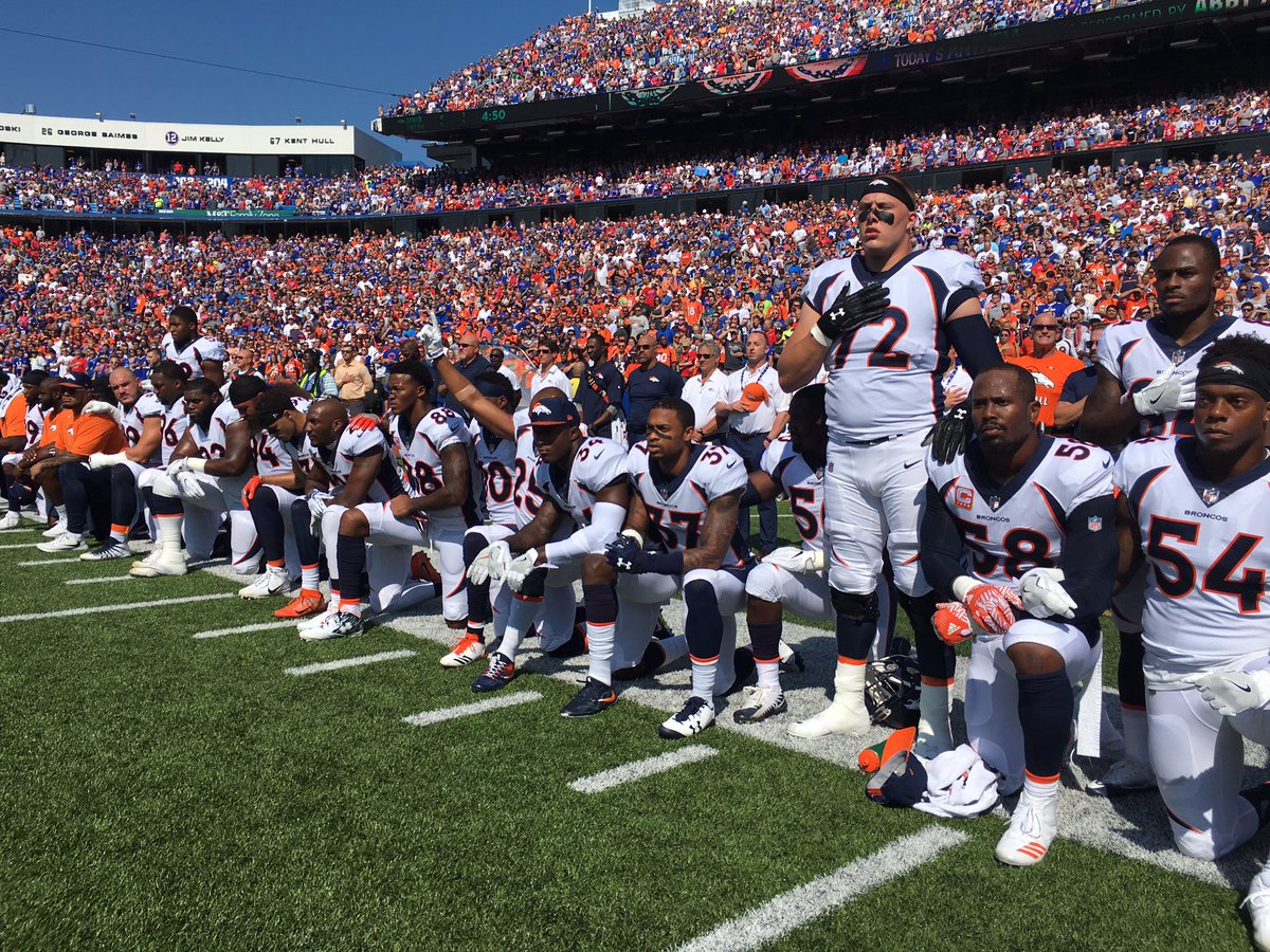 The Latest: At least 100 NFL players kneel or sit in protest