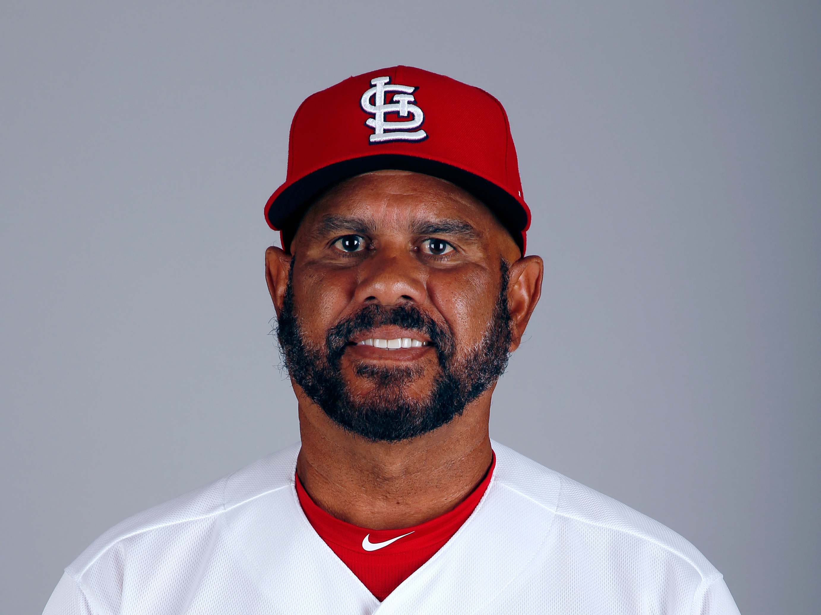 St. Louis Cardinals third base coach Jose Oquendo walks in the