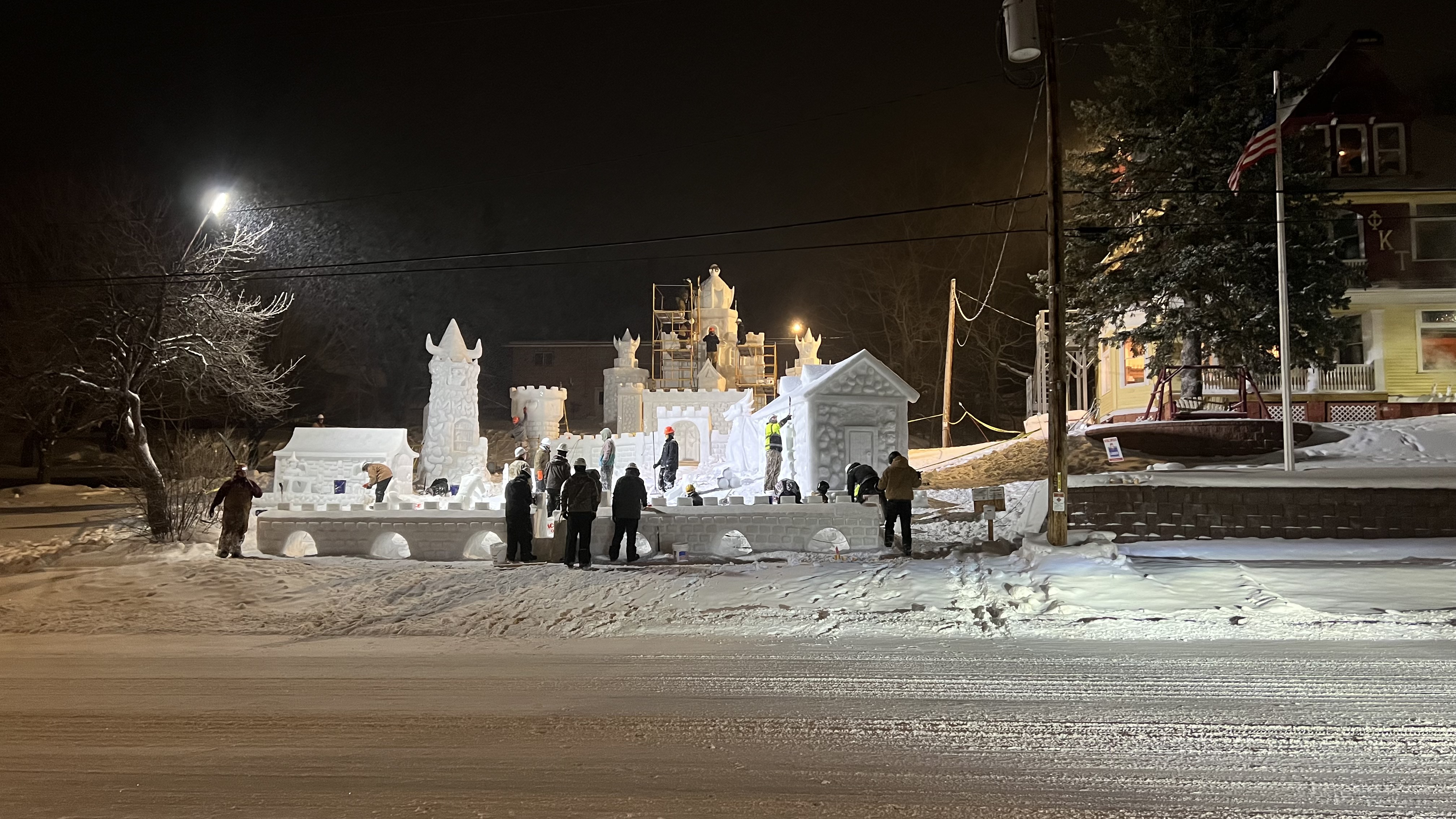 Students put the finishing touches on snow statues during Winter