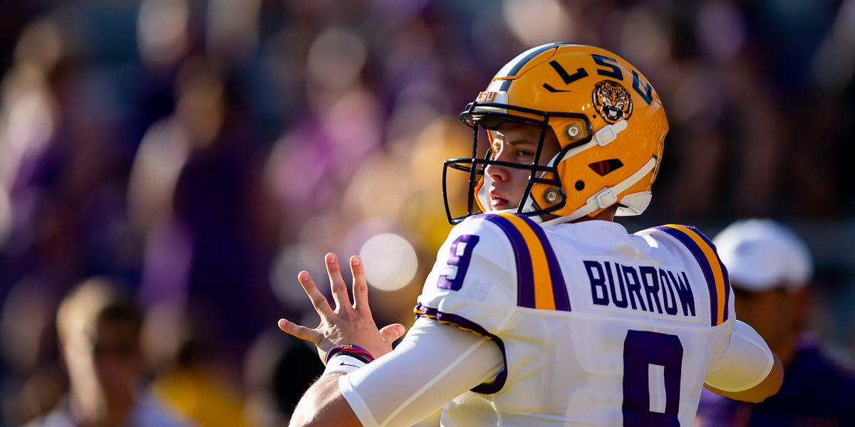 Joe Burrow LSU Tigers Unsigned White Jersey Throwing Photograph