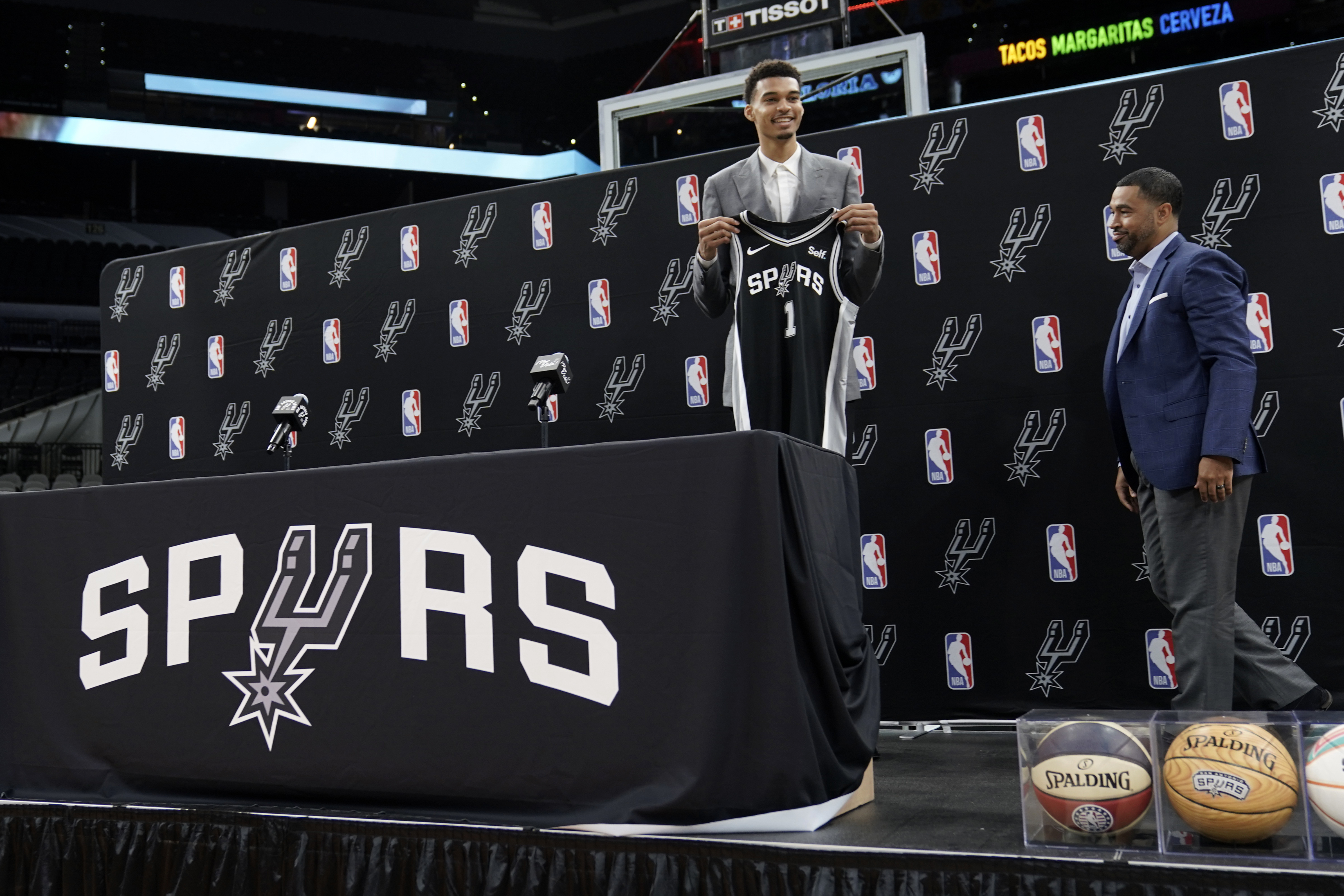 Fans line up to purchase San Antonio Spurs jerseys and T-shirts featuring  Victor Wembanyama, the team's first round pick in the NBA basketball draft,  following a watch party at the AT&T Center