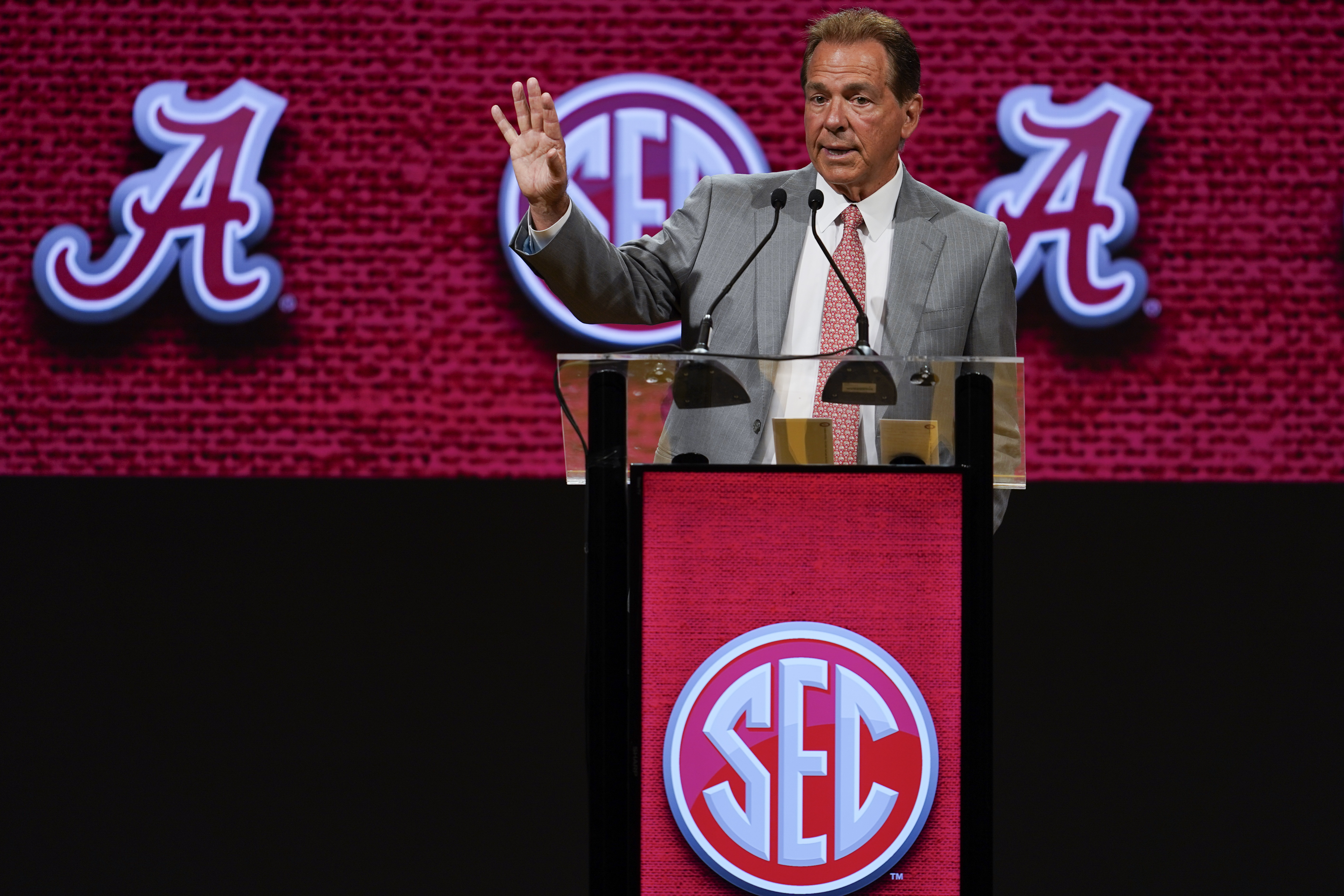 Alabama head coach Nick Saban, center, talks with defensive back