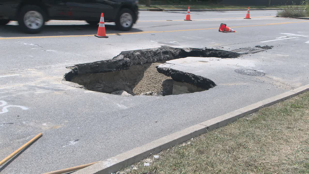 Drivers navigate around sinkhole caused by water main break in Clifton