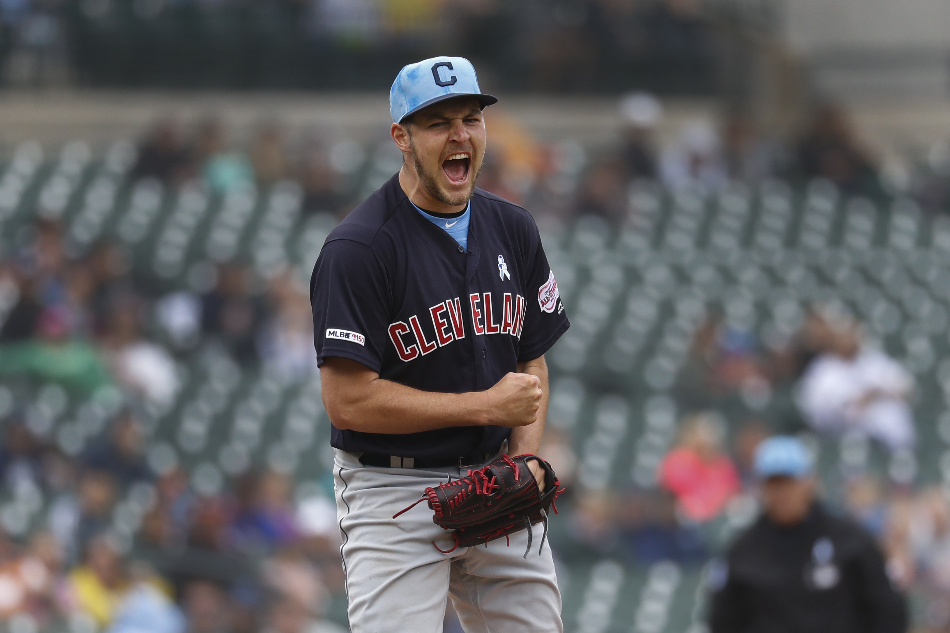 Cleveland Indians Trevor Bauer adorns a baseball with hair made