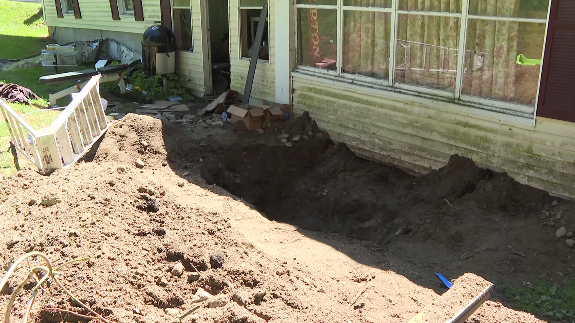 Man found buried in shallow grave in back yard, police say; son faces  charges