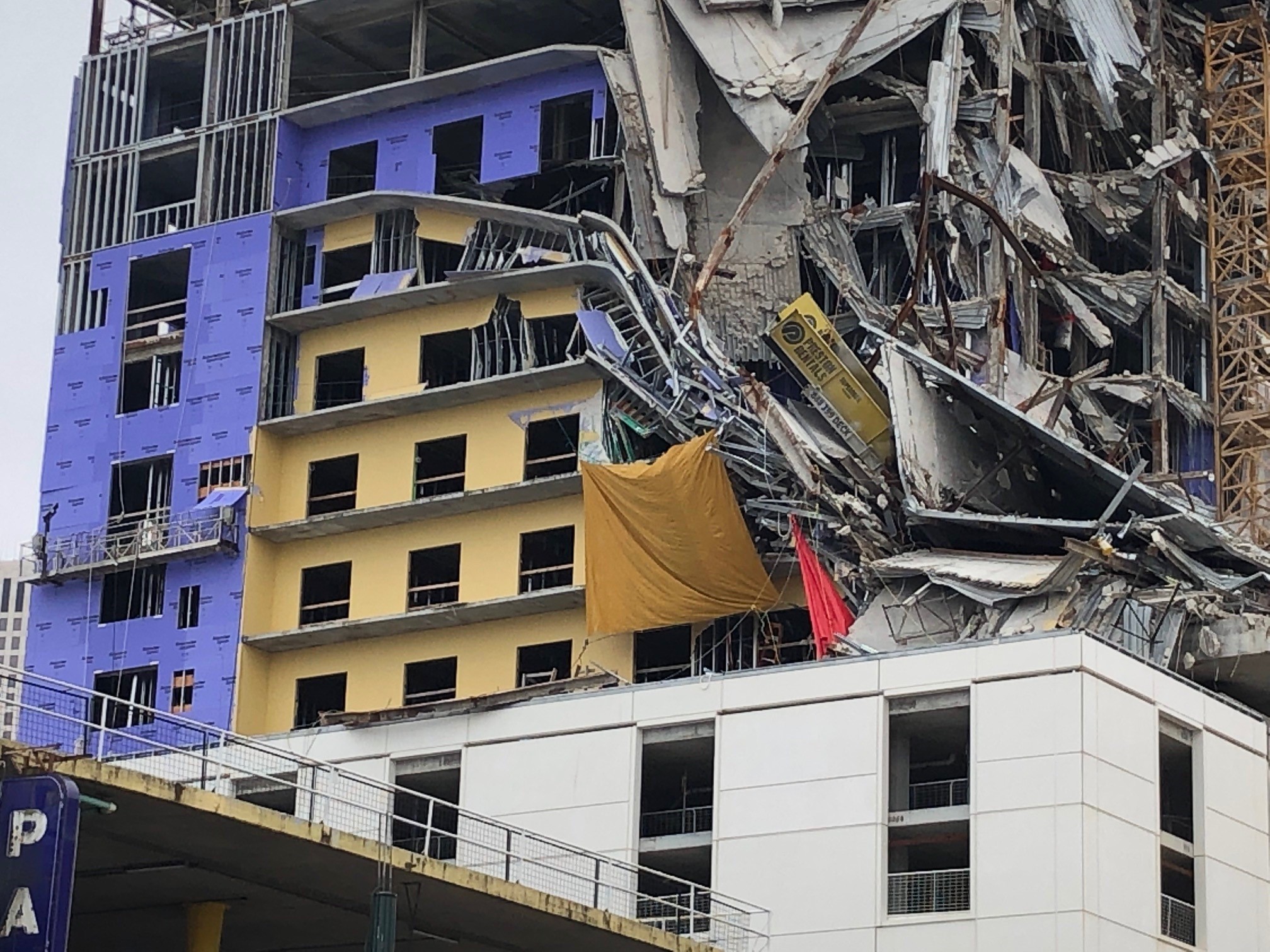 Crews replace tarp concealing worker's remains, find further collapse at  Hard Rock site