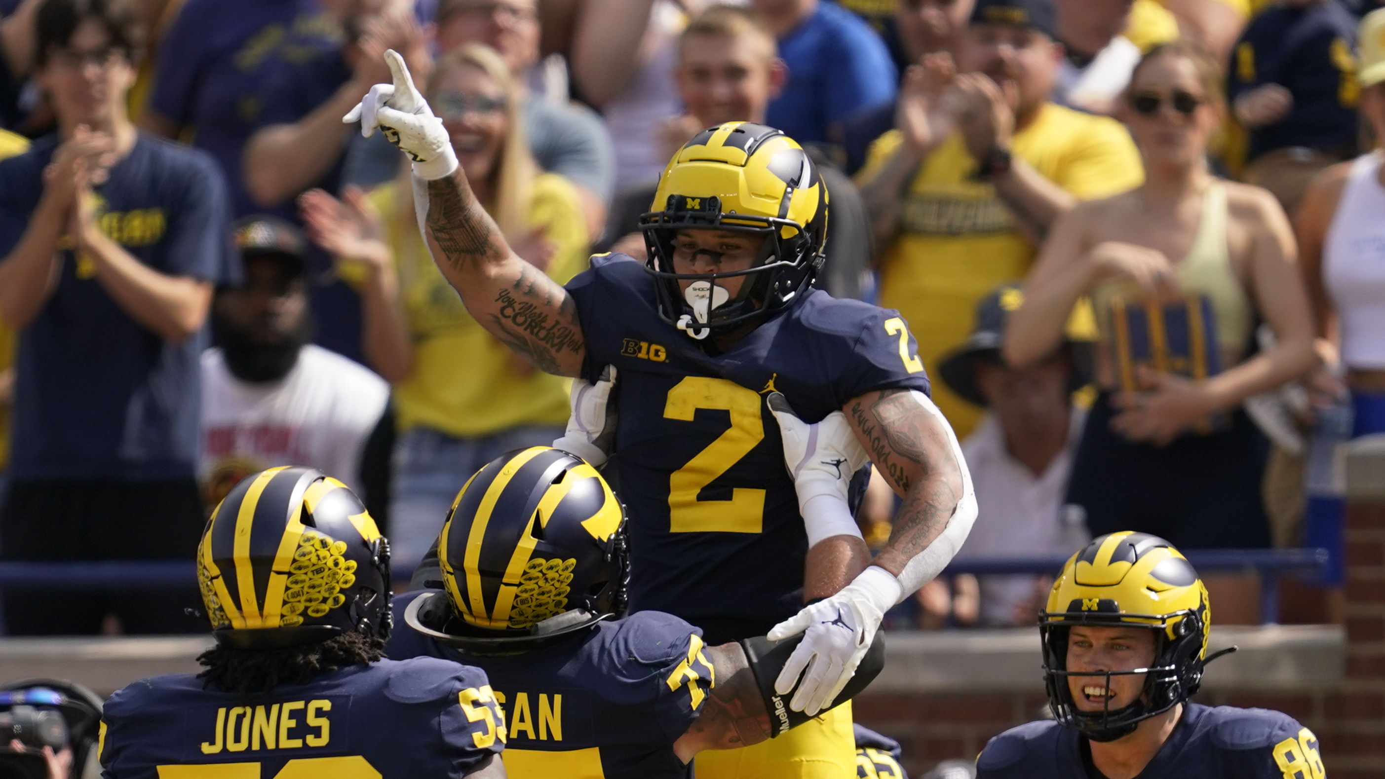 Corum scores 5 TDs No. 4 Michigan routs Connecticut 59 0