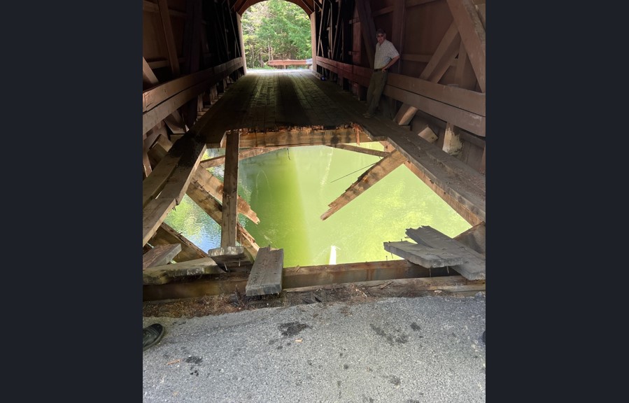 Overweight truck falls through deck of Babb's Covered Bridge