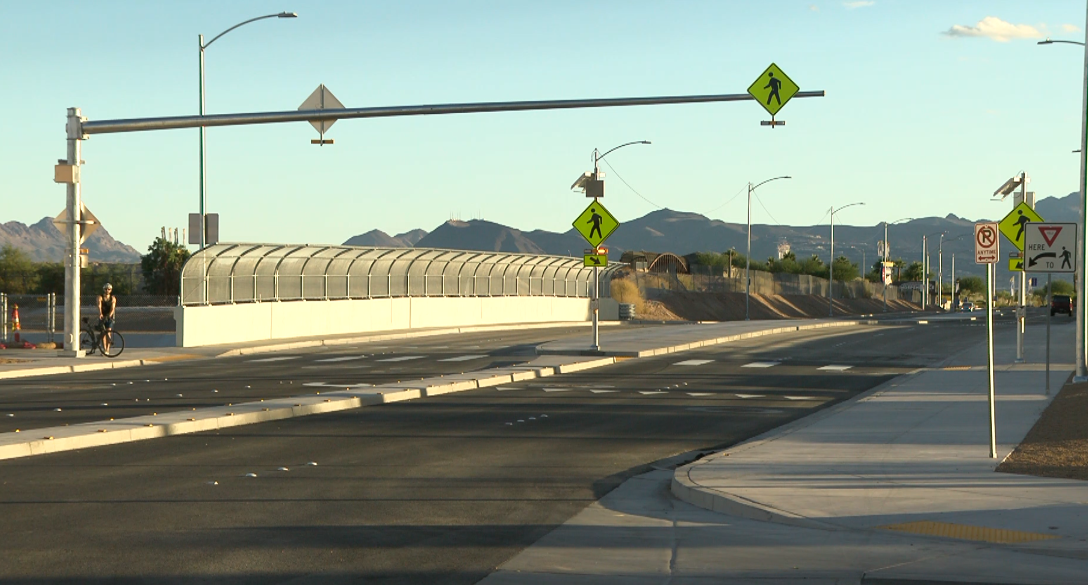 The newly opened Sloan Lane bridge over the Las Vegas Wash in the east valley, with fenced sides, new pavement, streetlights and pedestrian crossing signs (image: FOX5 Vegas)