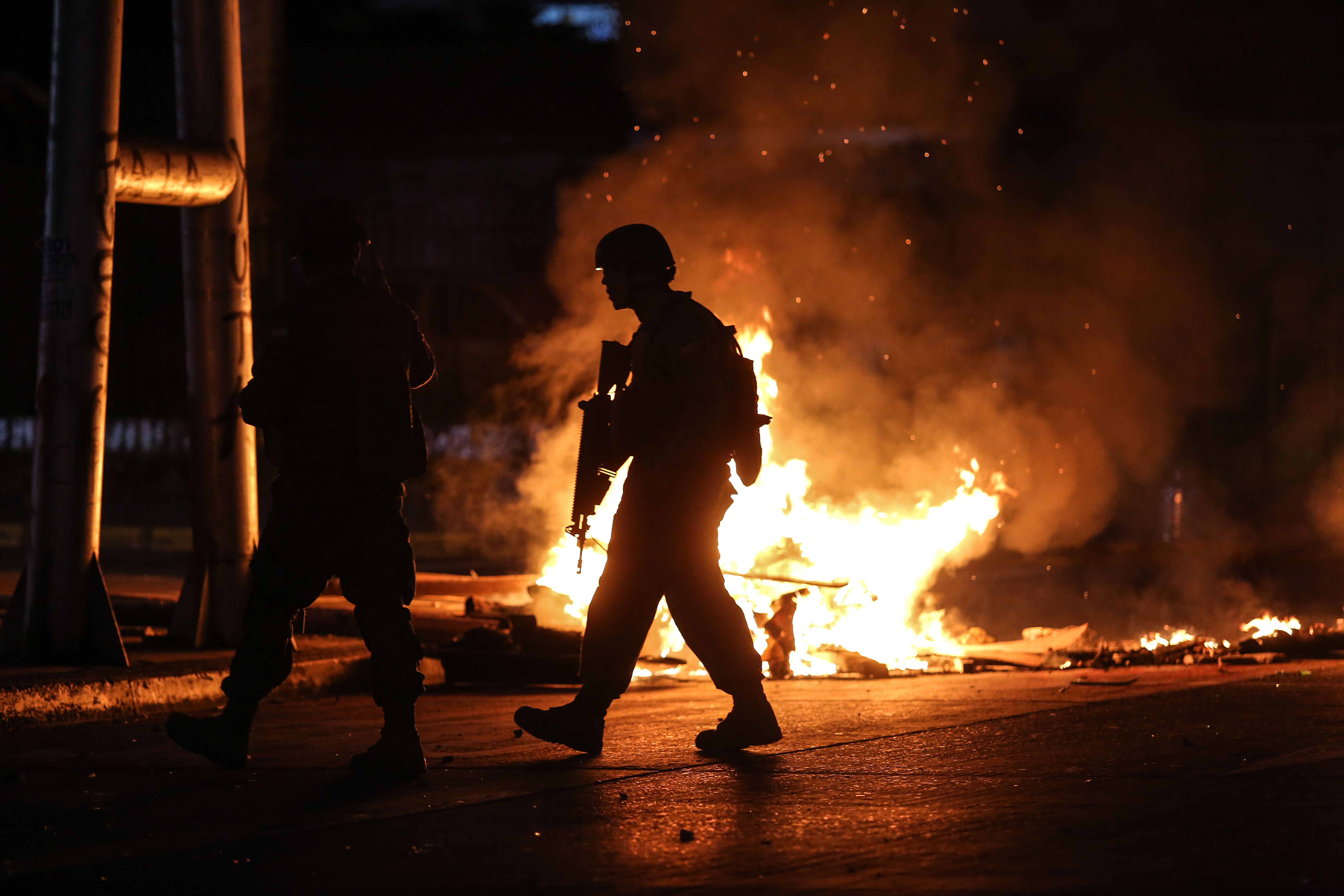 Soldiers patrol the streets of Concepcion, Chile, on October 20, 2019, during protests. - Fresh clashes broke out in Chile's capital Santiago on Sunday after two people died when a supermarket was torched overnight as violent protests sparked by anger over economic conditions and social inequality raged into a third day. (Photo by PABLO HIDALGO / AFP)