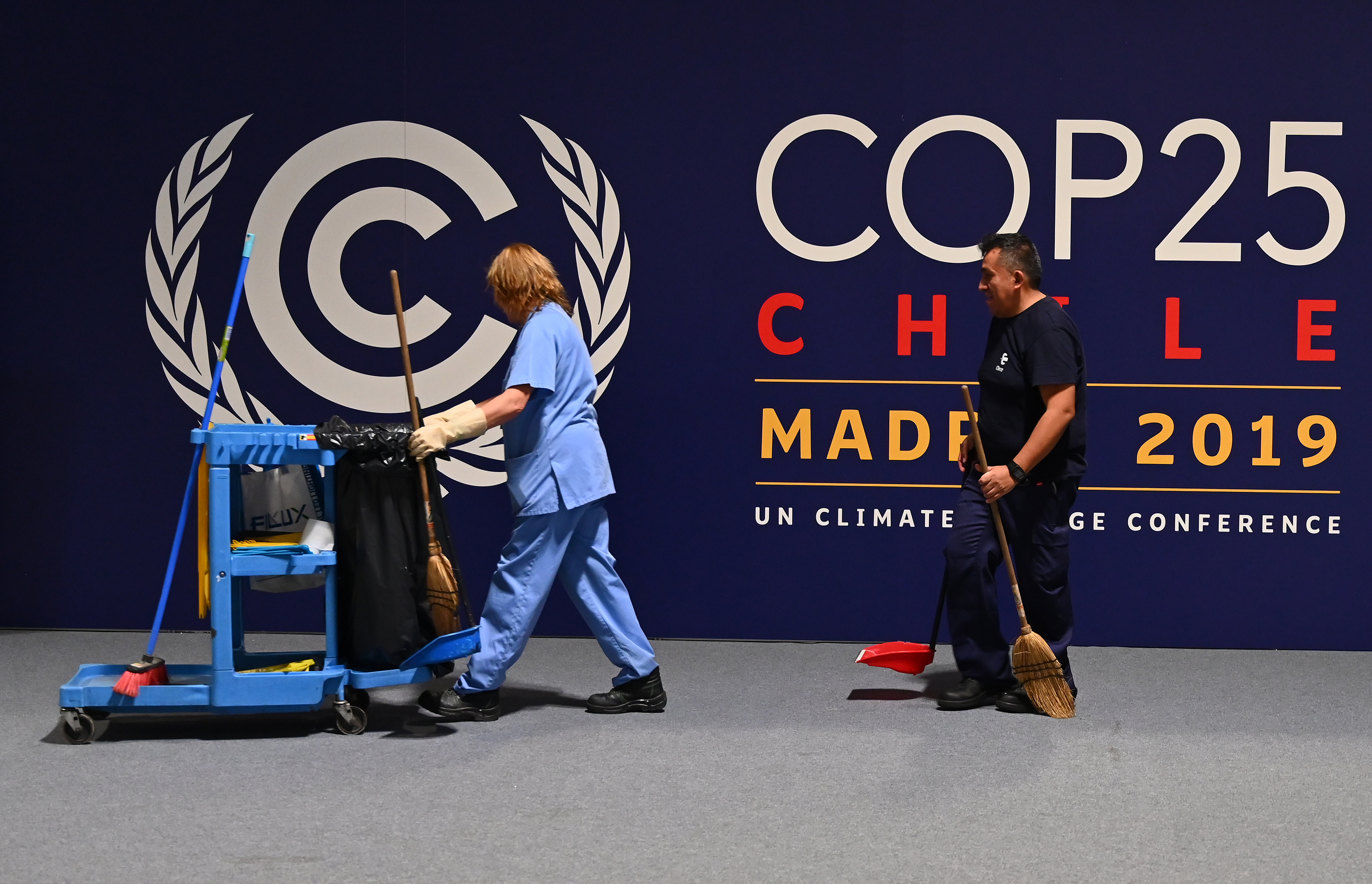 Workers clean the congress centre IFEMA in Madrid on November 27, 2019 where the COP25 climate summit will be held from December 2 to 13, 2019. (Photo by Gabriel BOUYS / AFP)