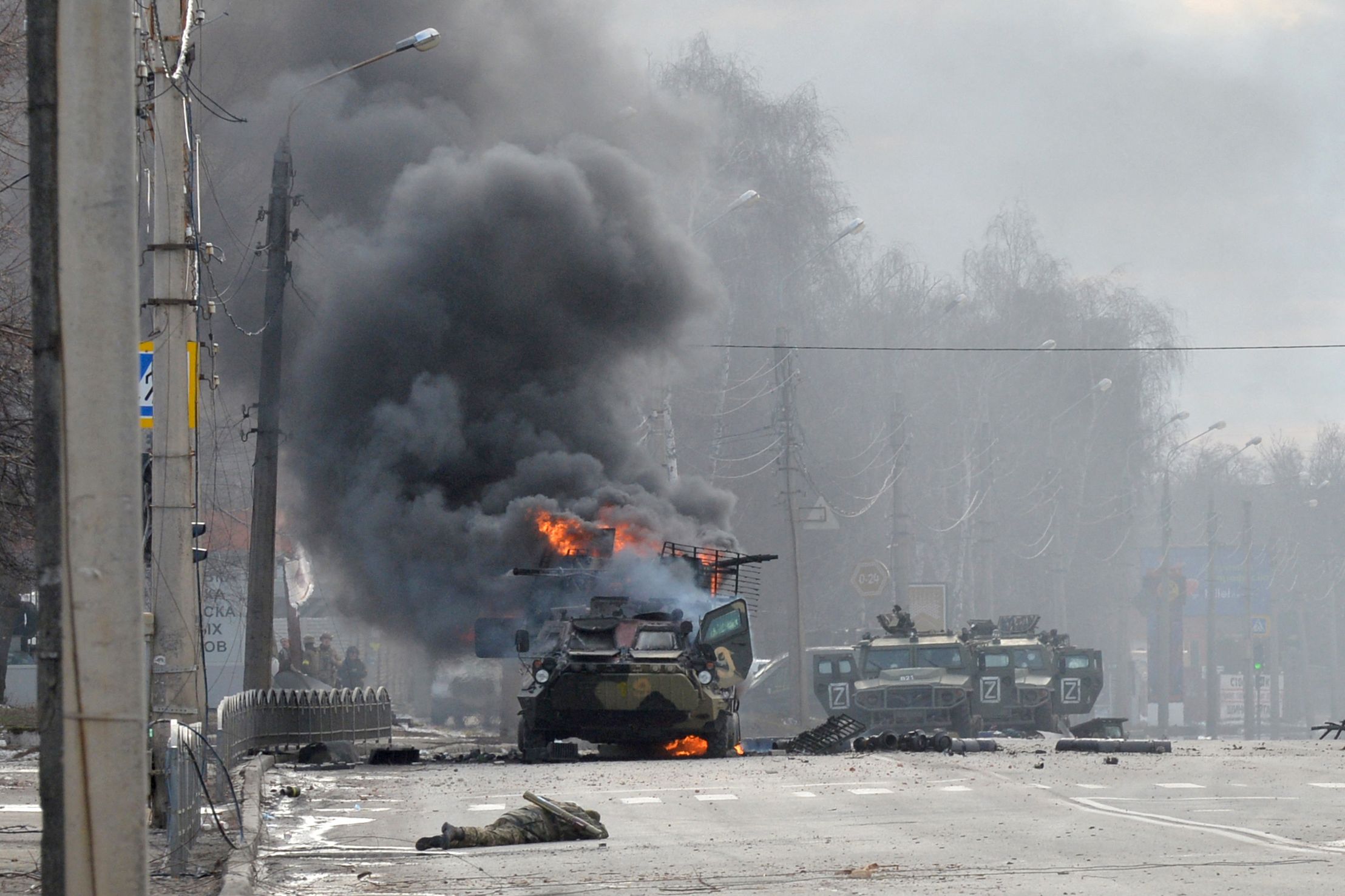 This photograph taken on February 26, 2022 shows a Russian Armoured personnel carrier (APC) burning during fight with the Ukrainian armed forces in Kharkiv. - Ukrainian forces secured full control of Kharkiv on February 27, 2022 following street fighting with Russian troops in the country's second biggest city, the local governor said. (Photo by Sergey BOBOK / AFP)
