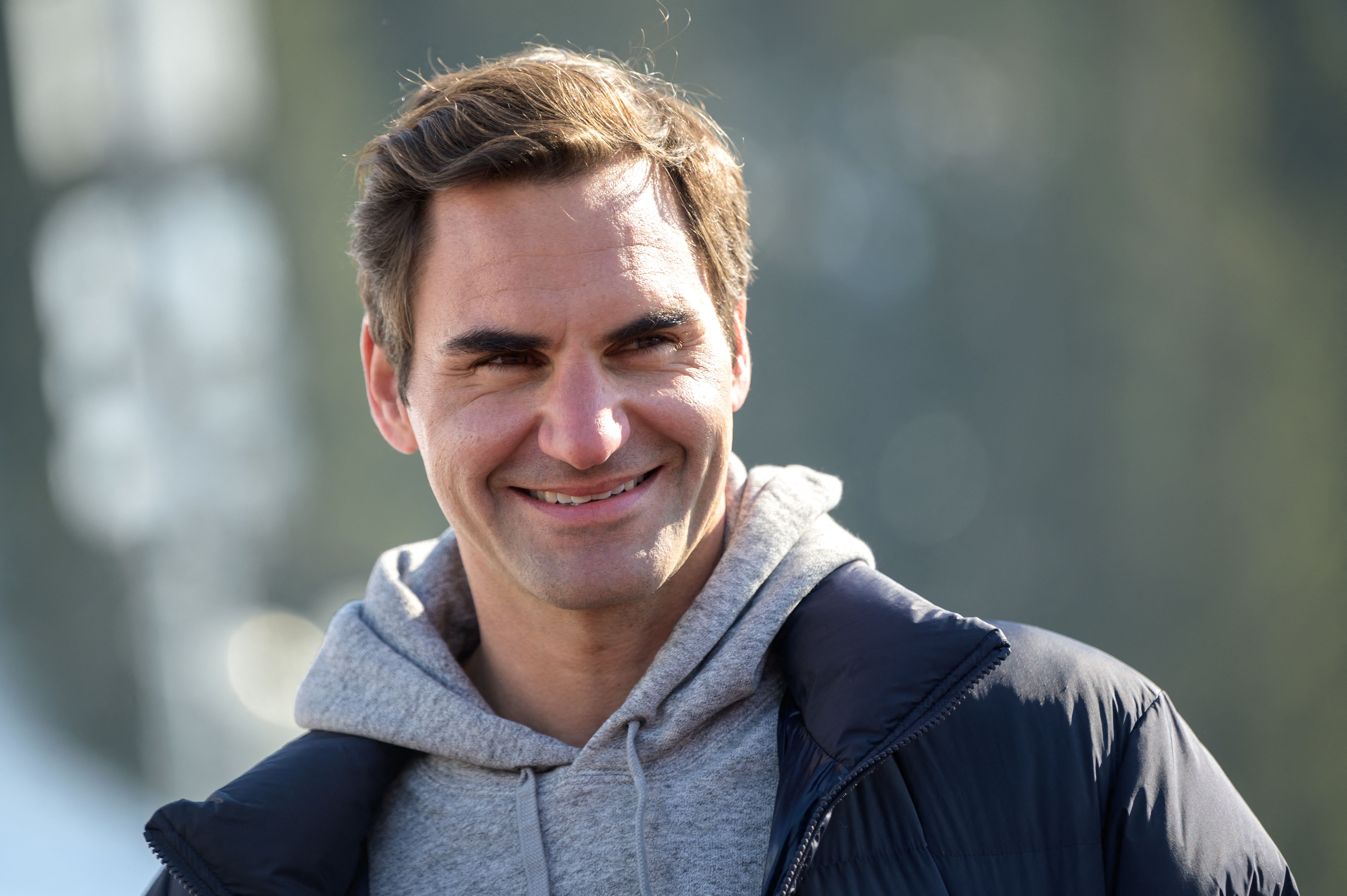 Former men's tennis world number one Swiss Roger Federer speaks at the arrival area of the Women's giant slalom event at the FIS Alpine Ski World Cup in Lenzerheide, on March 6, 2022. - Former men's tennis world number one Roger Federer plagued by recurring knee problems for the last two years hopes to make a comeback at the end of the summer, he told Swiss television. (Photo by Fabrice COFFRINI / AFP)