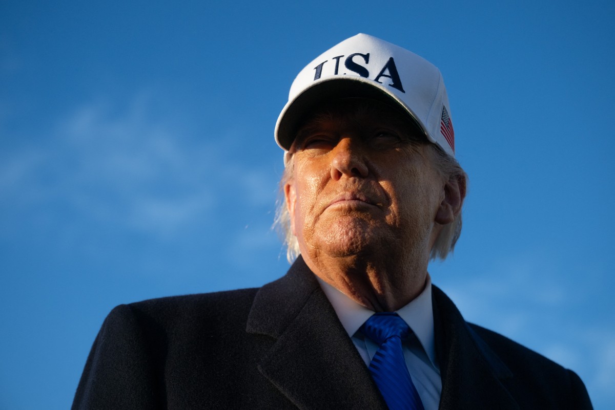 US President Donald Trump speaks to reporters before boarding Air Force One as he departs Joint Base Andrews in Maryland on March 13, 2026. President Trump is heading to Florida to spend the weekend at his Mar-a-Lago resort. (Photo by SAUL LOEB / AFP)