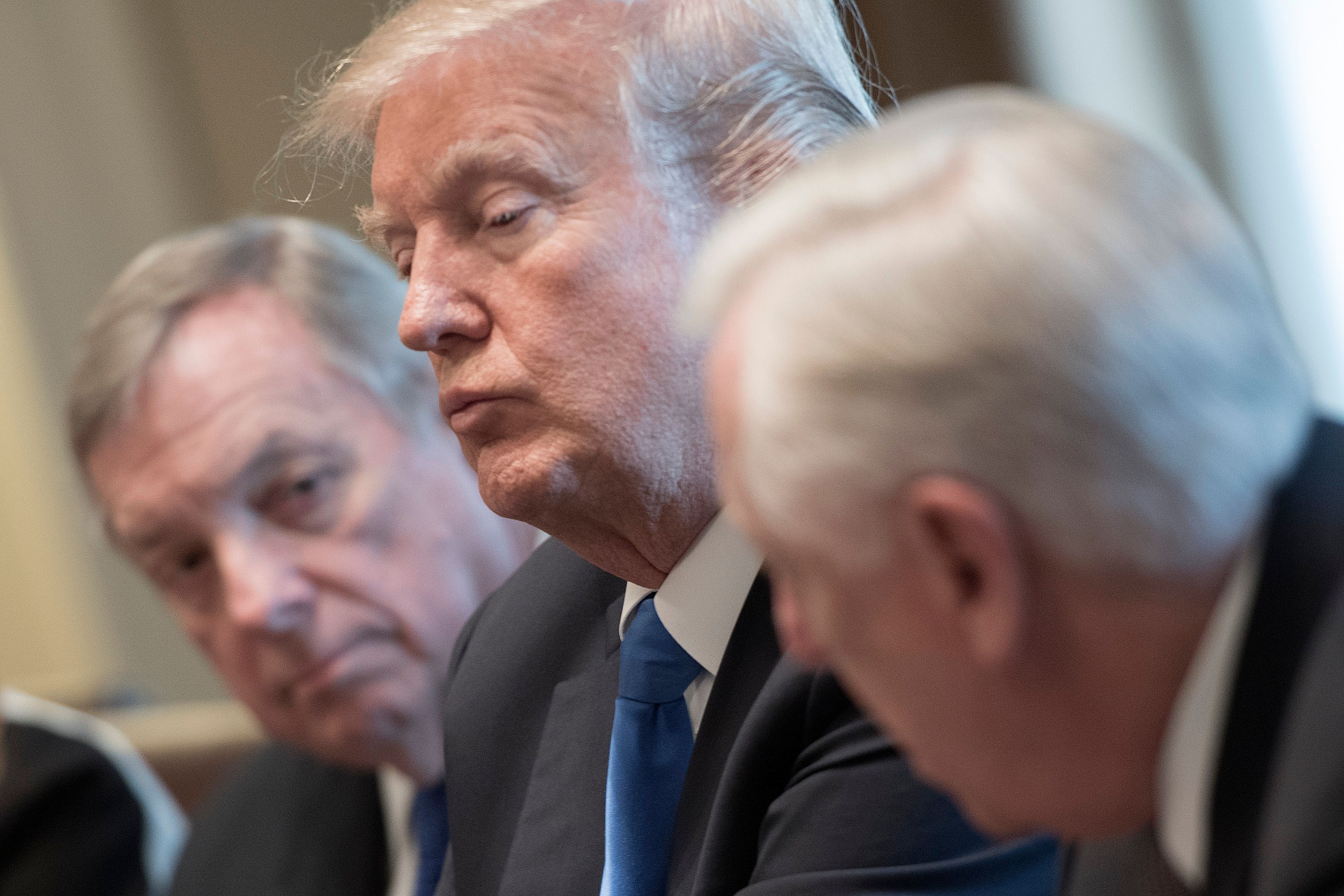US President Donald Trump (C) and US Senator Dick Durbin (L), D-Illinios, listen as US Congressman Steny Hoyer (R), D-Maryland speaks during a meeting with bipartisan members of the Senate on immigration at the White House in Washington, DC, on January 9, 2018. / AFP PHOTO / JIM WATSON