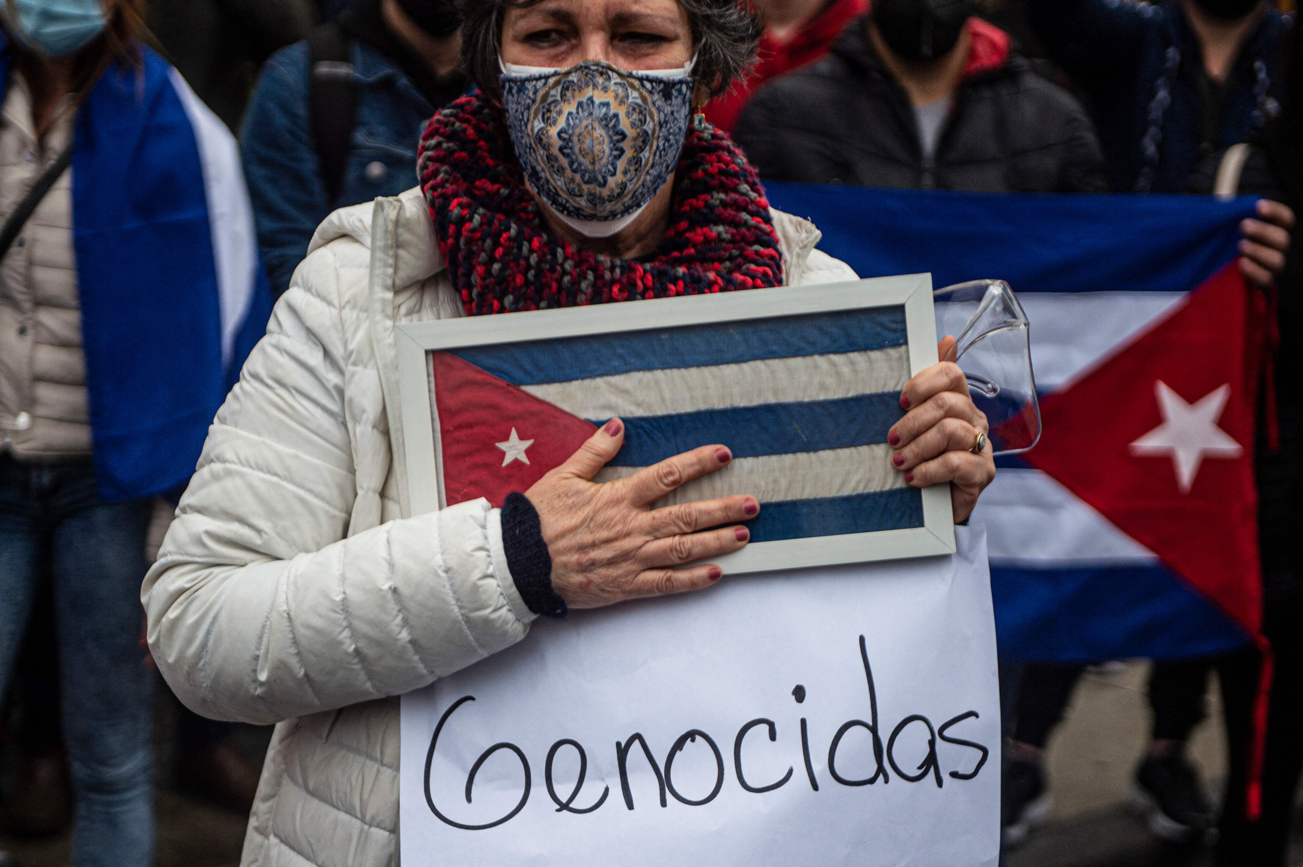 Cuban citizens residing in Peru demonstrate against Cuban government of President Miguel Diaz-Canel outside the Cuban Embassy in Lima, on July 13, 2021. - A man died in an anti-government protest on Monday on the outskirts of Havana, the Cuban interior ministry said on Tuesday. Unprecedented demonstrations against the single party communist regime broke out on Sunday, spilling over into Monday and Tuesday and have been met with a wave of arrests and allegations of police brutality. (Photo by Ernesto BENAVIDES / AFP)