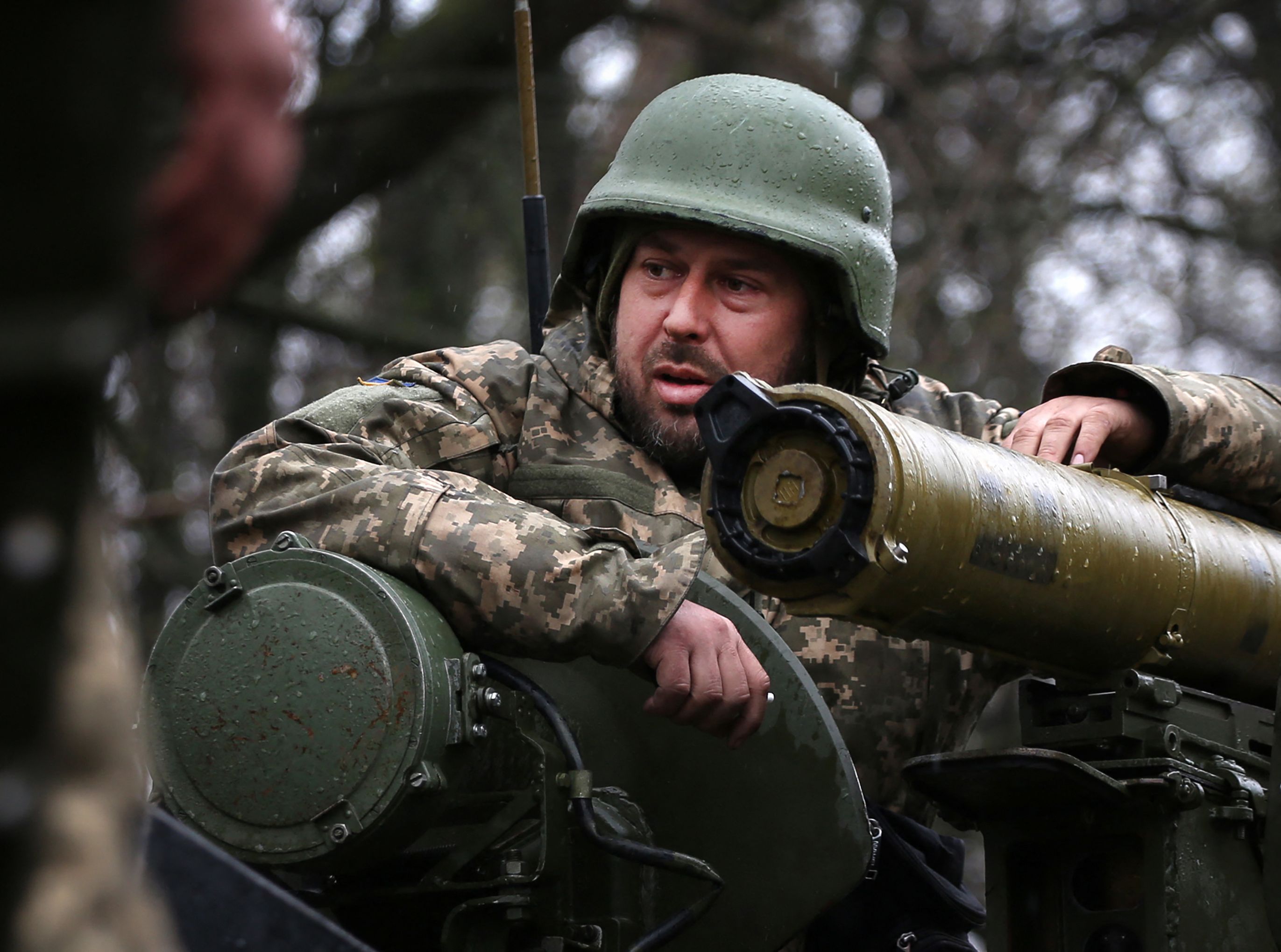 A Ukrainian soldier stands on an armoured personnel carrier (APC), not far from the front-line with Russian troops, in Izyum district, Kharkiv region on April 18, 2022, during the Russian invasion of Ukraine. (Photo by Anatolii Stepanov / AFP)