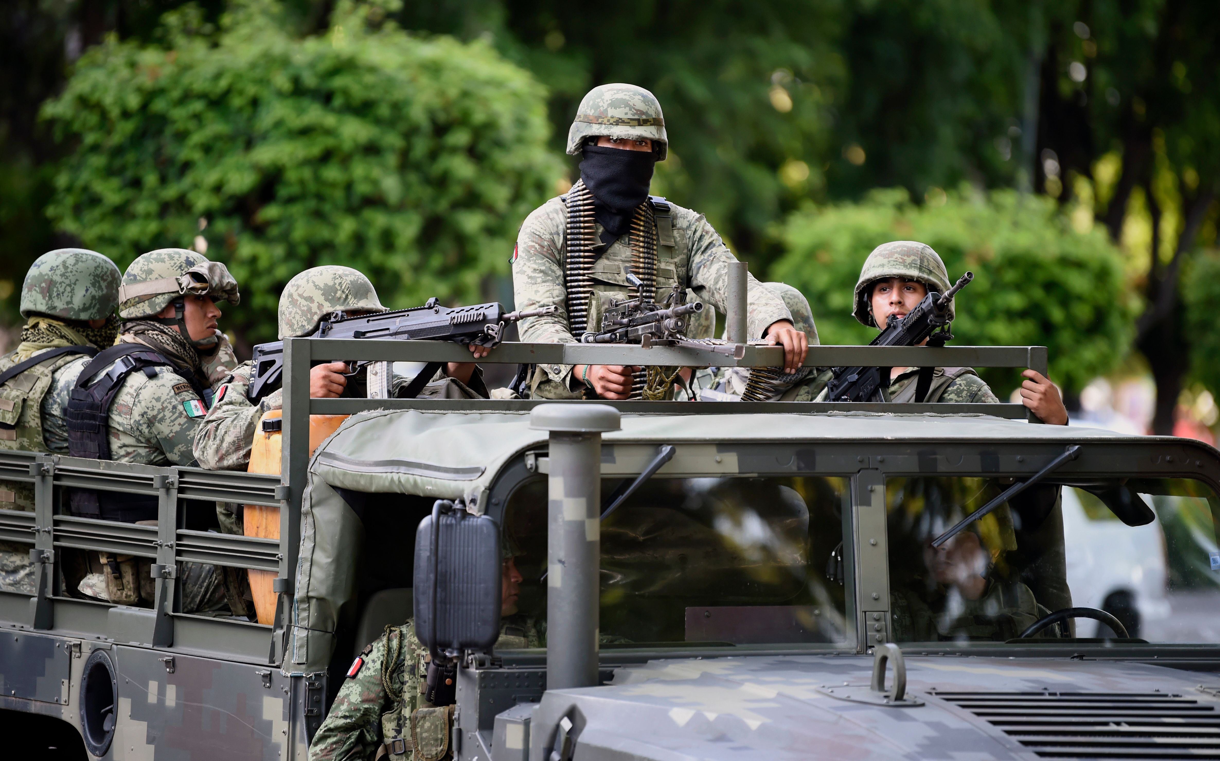 Soldiers patrol outside the government palace in Culiacan, Sinaloa state, Mexico, on October 18, 2019. - Mexico's president faced a firestorm of criticism Friday as his security forces confirmed they arrested kingpin Joaquin "El Chapo" Guzman's son, then released him when his cartel responded with an all-out gun battle. (Photo by ALFREDO ESTRELLA / AFP)
