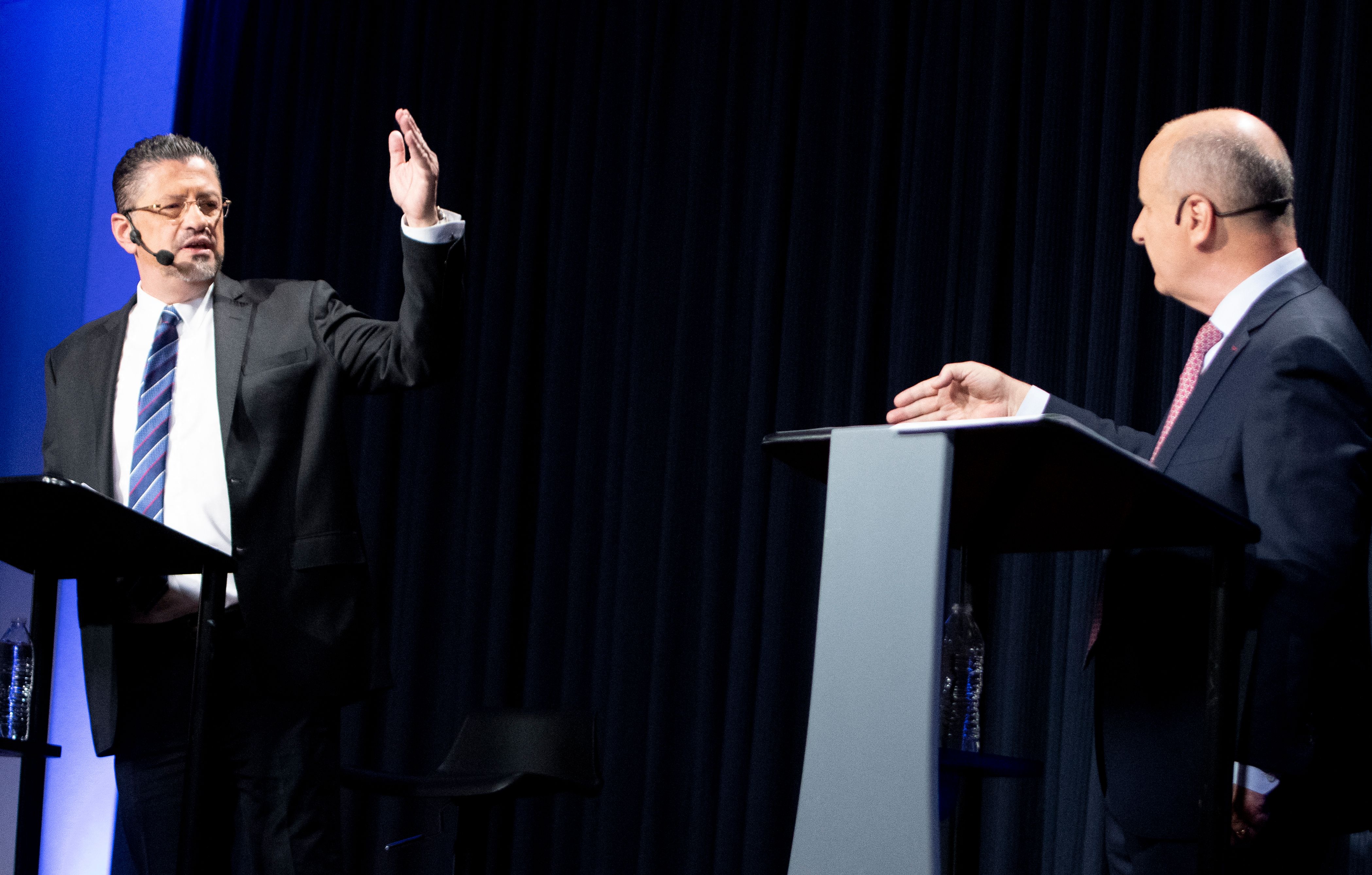 Costa Rican presidential candidates Rodrigo Chaves (L) of the Social Democratic Progress party and Jose Maria Figueres of the National Liberation Party take part in a debate in San Jose, on March 29, 2022. - Costa Rica will hold its presidential election in the second round on April 3, 2022. (Photo by Ezequiel BECERRA / AFP)
