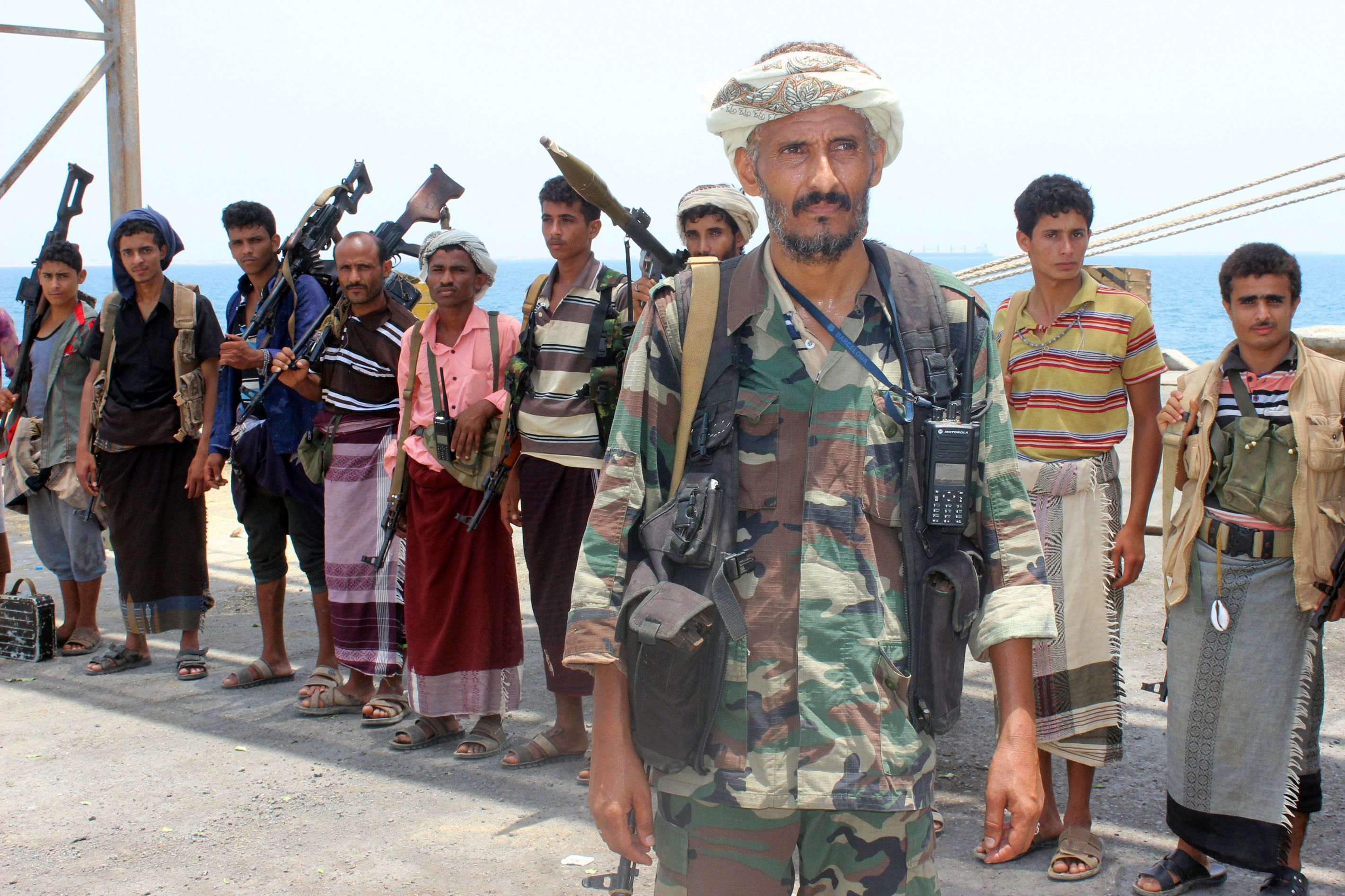 Huthi rebels stand at attention on May 11, 2019, in the Red Sea port of Hodeidah, ahead of their withdrawal. - A senior pro-government official in Yemen accused Huthi rebels of faking an announced pullout Saturday from three Red Sea ports, as a UN source said monitoring of the much delayed withdrawal in Hodeida province was underway. (Photo by STR / AFP)