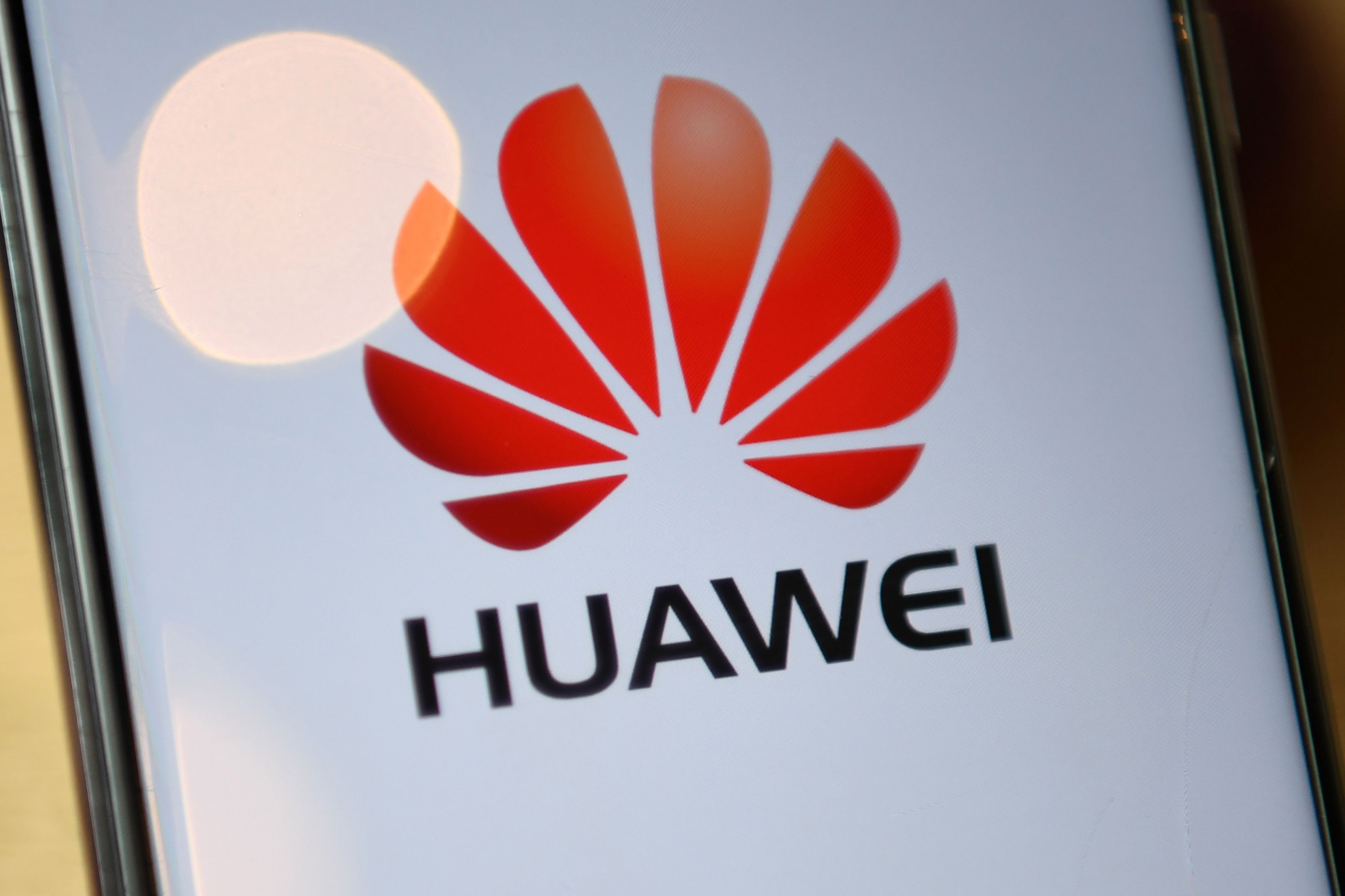 The logo of Chinese company Huawei is seen on the screen of a Huawei mobile phone in London on July 14, 2020. - Britain on Tuesday ordered its telecom providers to stop purchasing 5G equipment from China's Huawei giant from the start of next year, and to strip out all of its equipment by 2027. (Photo by DANIEL LEAL-OLIVAS / AFP)