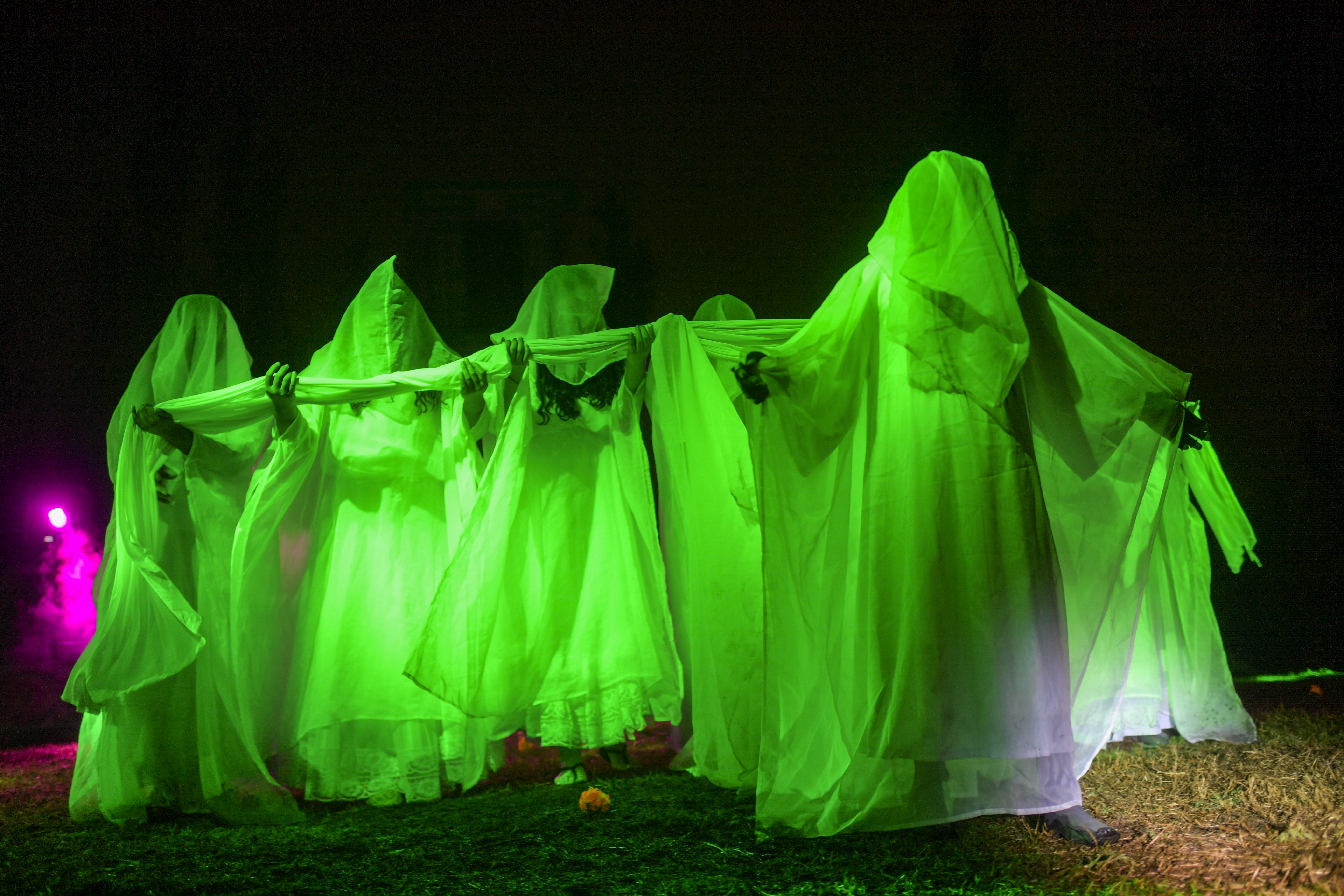 Actress Nayeli Cortez (R) performs in the La Llorona folk play, at the Cuemanco pier in the "chinampas" of Lake Xochimilco, small artificial islands and causeways created by the Aztecs in wetlands, in southern Mexico City, on October 18, 2020, amid the COVID-19 novel coronavirus pandemic. - The traditional staging of "La Llorona", a legend from Aztec mythology, is being held to 30% of capacity amid the sanitary restrictions imposed to fight COVID-19 and serves to remember the victims of the pandemic. (Photo by Pedro PARDO / AFP)