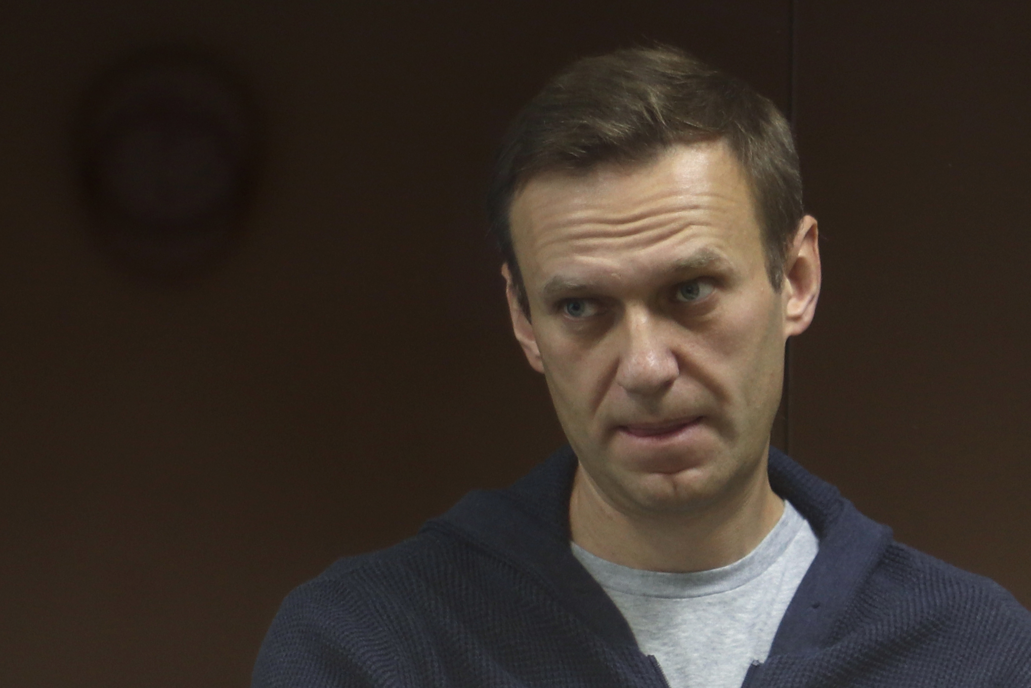 This handout picture provided by the Babushkinsky district court on February 12, 2021, shows Russian opposition leader Alexei Navalny, charged with defaming a World War II veteran, standing inside a glass cell during a court hearing in Moscow. (Photo by Handout / Moscow's Babushkinsky district court press service / AFP) / RESTRICTED TO EDITORIAL USE - MANDATORY CREDIT "AFP PHOTO / Moscow's Babushkinsky district court press service / handout " - NO MARKETING - NO ADVERTISING CAMPAIGNS - DISTRIBUTED AS A SERVICE TO CLIENTS