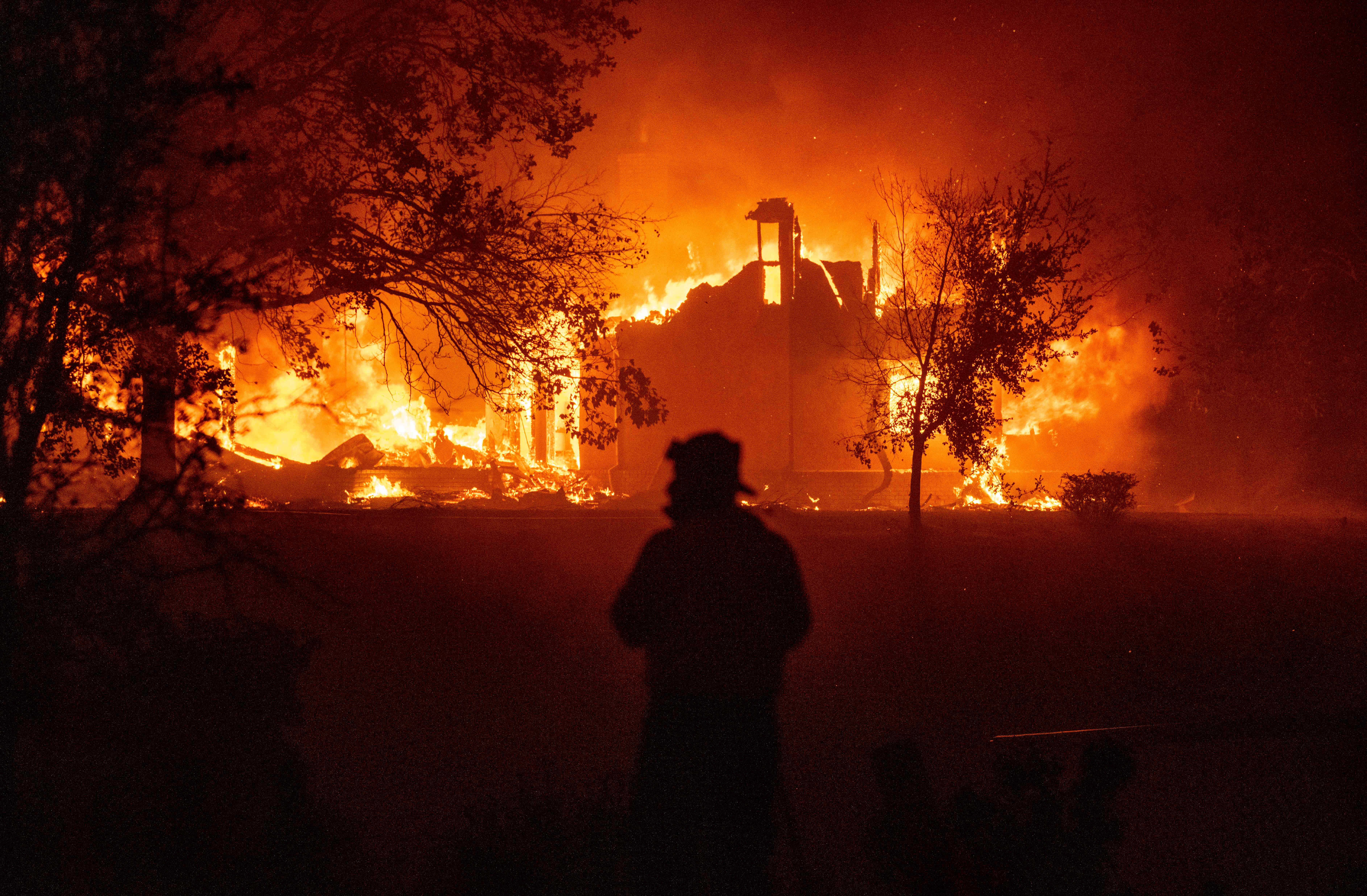 TOPSHOT - A home burns in Vacaville, California during the LNU Lightning Complex fire on August 19, 2020. - As of the late hours of August 18,2020 the Hennessey fire has merged with at least 7 fires and is now called the LNU Lightning Complex fires. Dozens of fires are burning out of control throughout Northern California as fire resources are spread thin. (Photo by JOSH EDELSON / AFP)