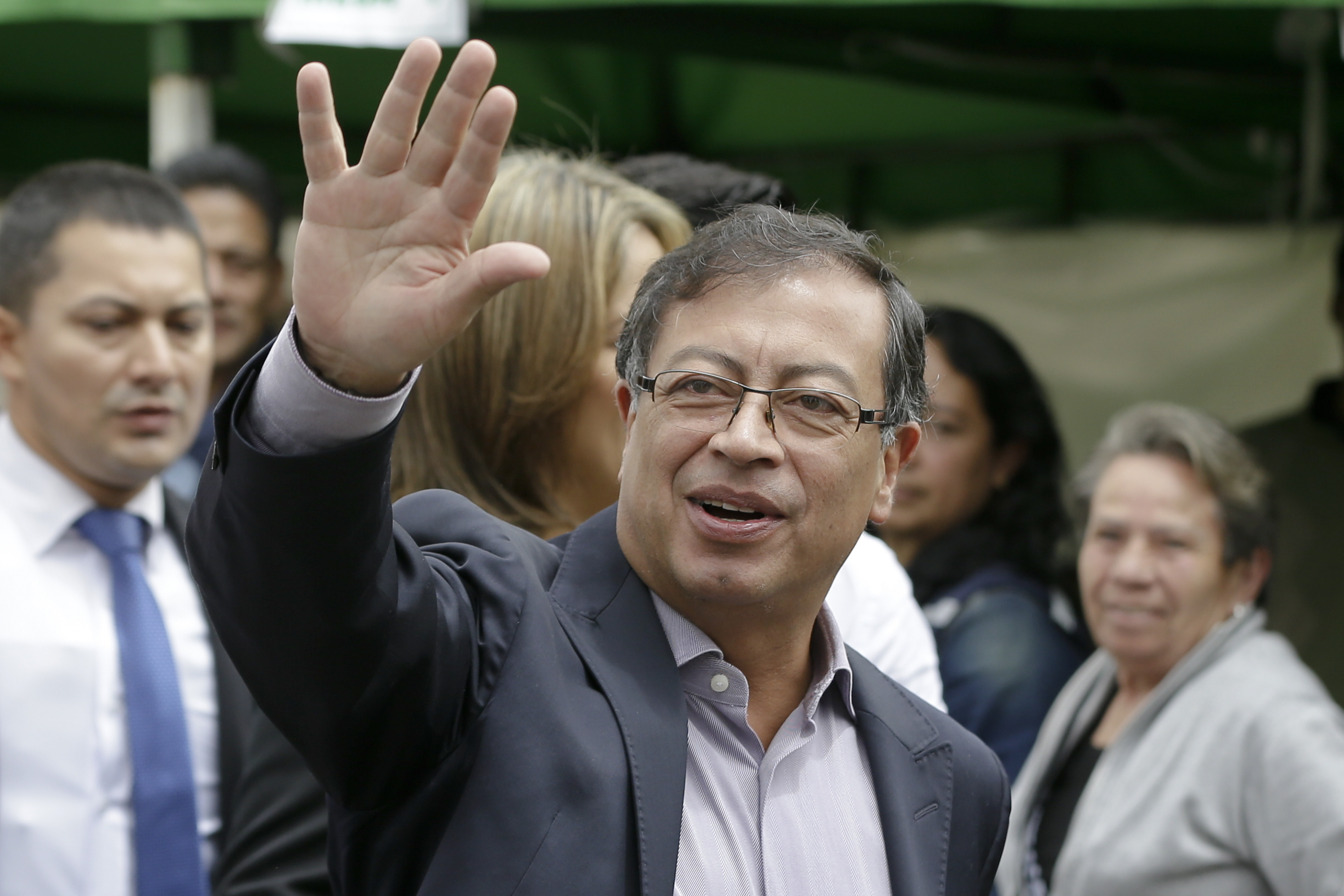 Gustavo Petro, presidential candidate for Colombia Humana, waves before voting in the presidential election in Bogota, Colombia, Sunday, May 27, 2018. (AP Photo/Ricardo Mazalan)