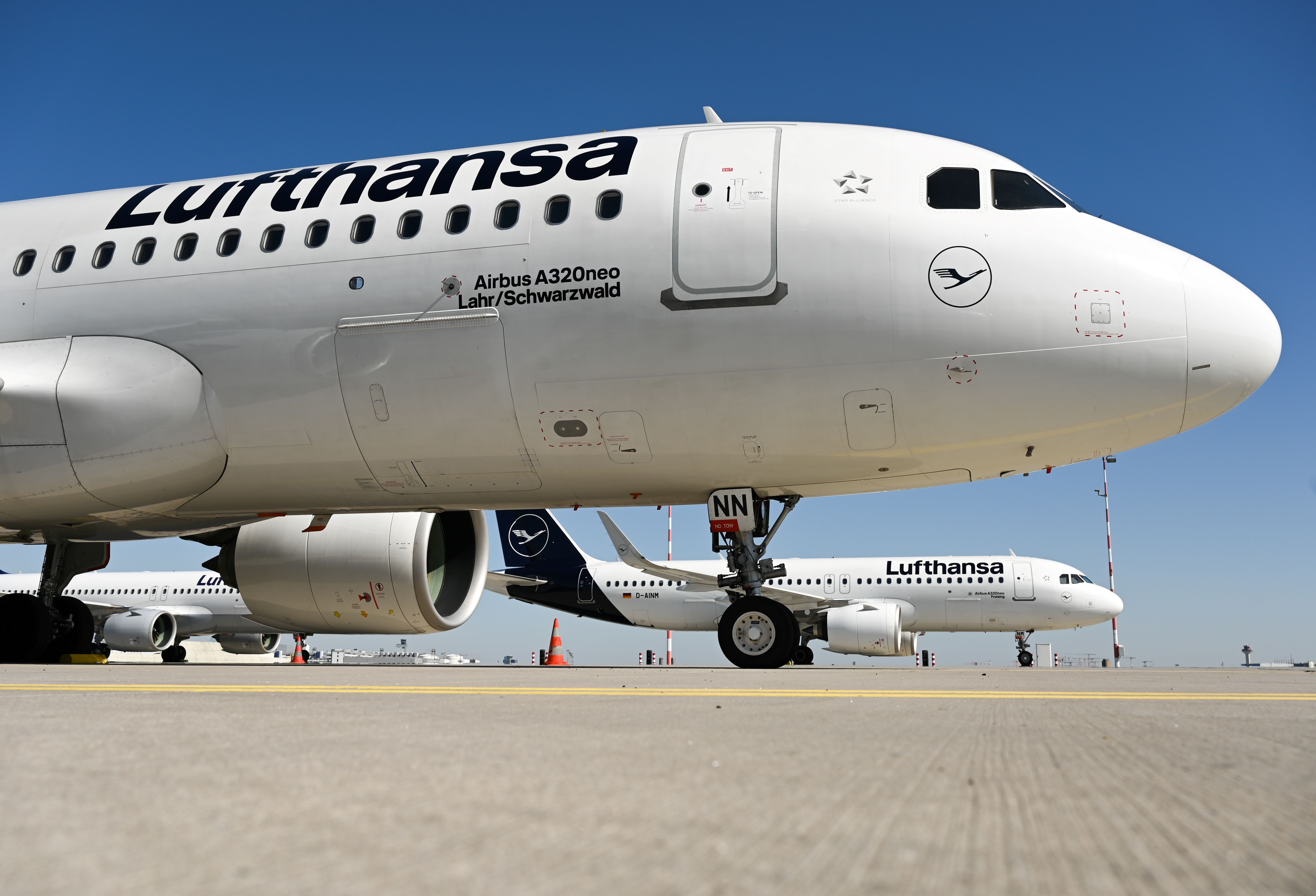 (FILES) In this file photo taken on March 23, 2020 Aircrafts of German airline group Lufthansa are immobilised next to the runway that has been closed at the airport in Frankfurt, Germany. - A rescue programme for the coronavirus-stricken airline giant Lufthansa has been reached according to Lufthansa on May 25, 2020. (Photo by Arne Dedert / POOL / AFP)
