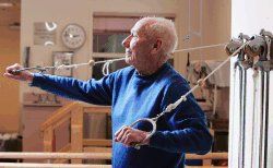 Arthur Zitzner, 93, works his arms on a pulley exerciser at the Green Hill retirement home where he lives in West Orange, N.J., Monday, April 3, 2006. Physical fitness protects against high blood pressure, high cholesterol, heart disease, stroke and diabetes, all risk factors for Alzheimer's and other forms of dementia. (AP Photo/Mike Derer)