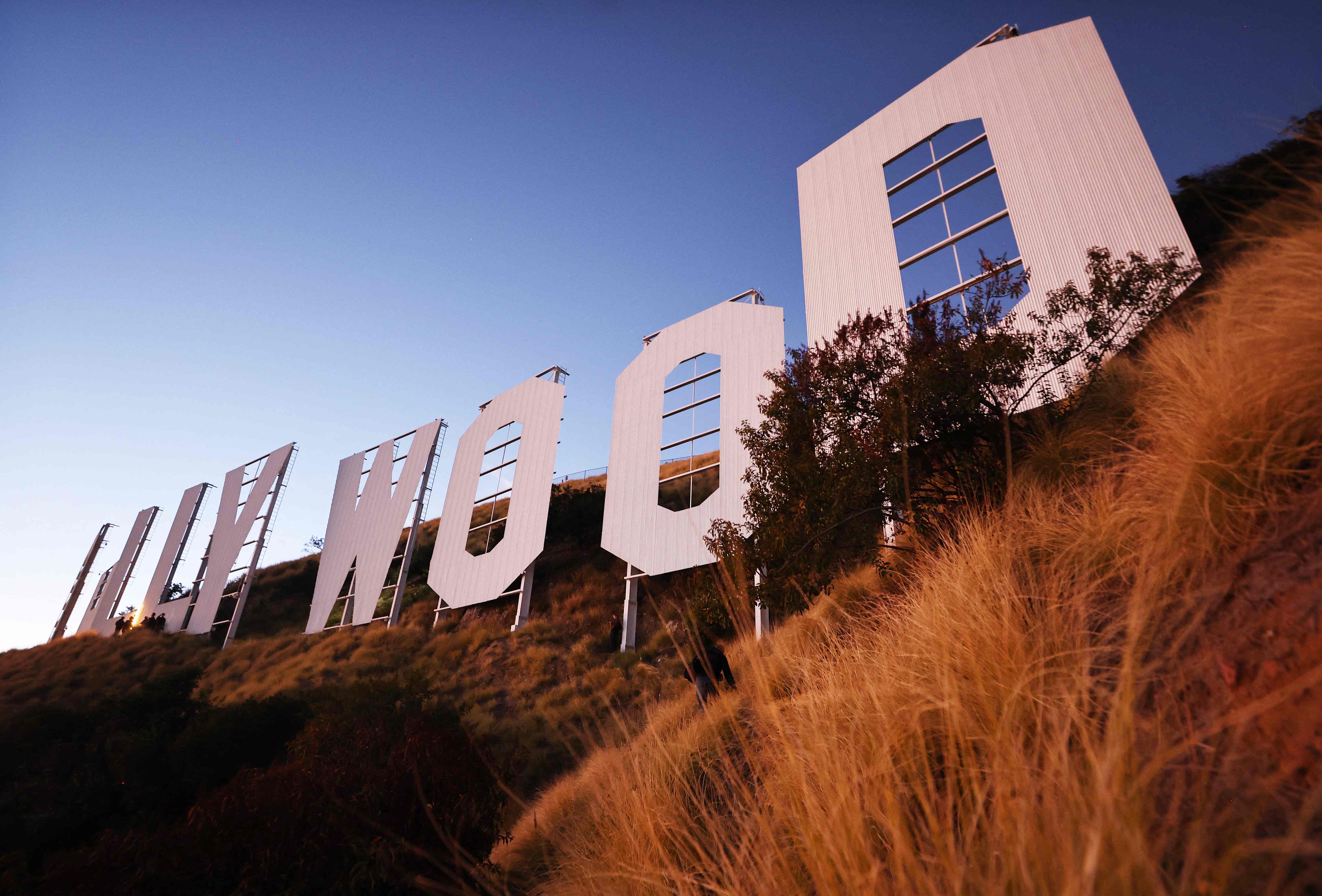 LOS ANGELES, CALIFORNIA - DECEMBER 08: The historic Hollywood sign stands after sunset on the 100th birthday of the iconic sign first being illuminated on December 8, 2023 in Los Angeles, California. The Hollywood Sign Trust has been honoring the sign�s centennial year and held a special anniversary celebration marking the day in 1923 when the sign was first lit with 4,000 20-watt bulbs. Mario Tama/Getty Images/AFP (Photo by MARIO TAMA / GETTY IMAGES NORTH AMERICA / Getty Images via AFP)