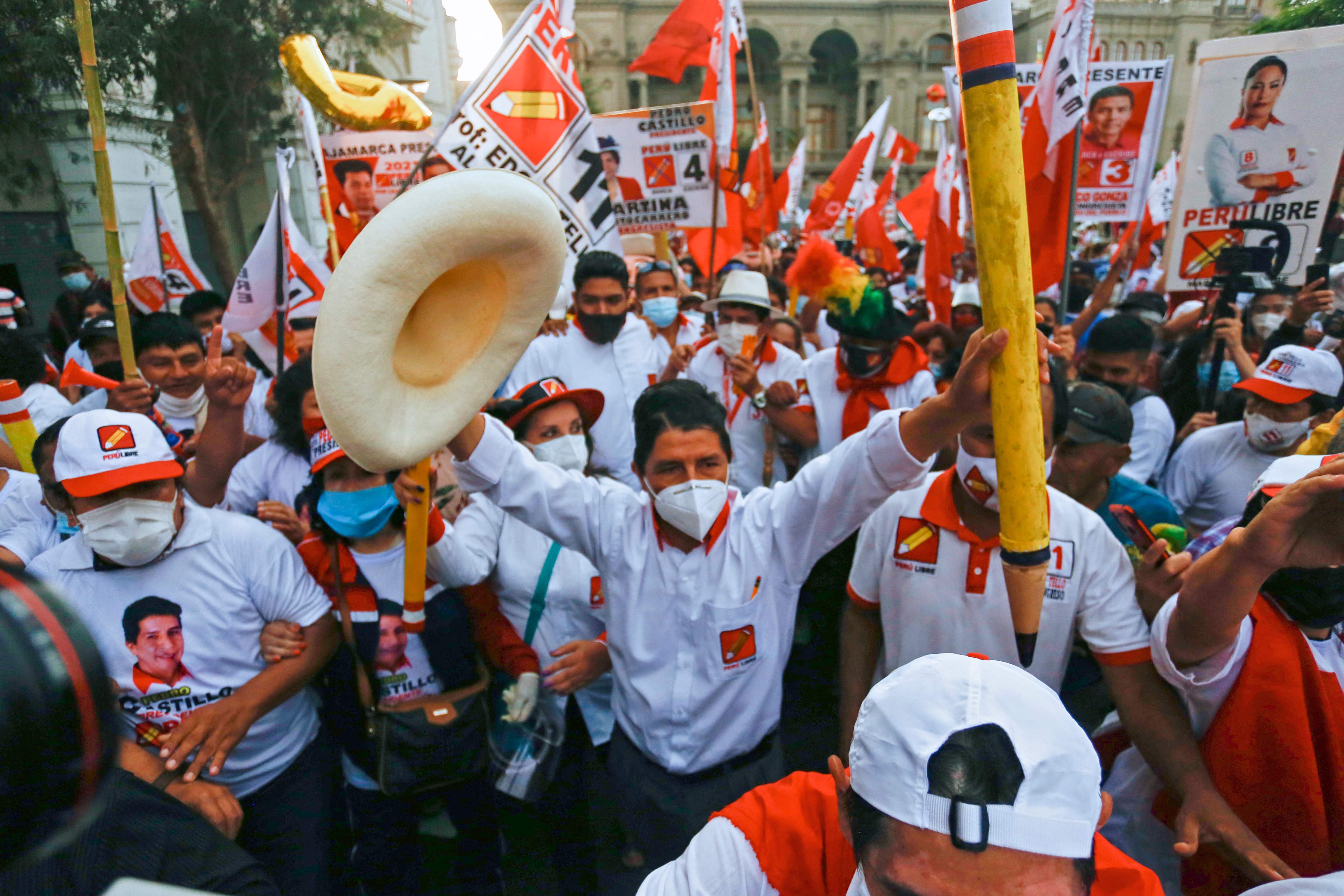 Peruvian presidential candidate for the radical leftist party Peru Libre (Free Peru), Pedro Castillo, holds up a giant pencil and a hat during the closing rally of his campaign in Lima on April 8, 2021. - Castillo 51-year-old school teacher native of Cajamarca, aspires to surprise the elections in Peru, after leaving anonymity in 2017 by leading a long strike by the teachers. He gained prominence with options to move on to the decisive second round, during the electoral debates, according to the polls. (Photo by Gian MASKO / AFP)