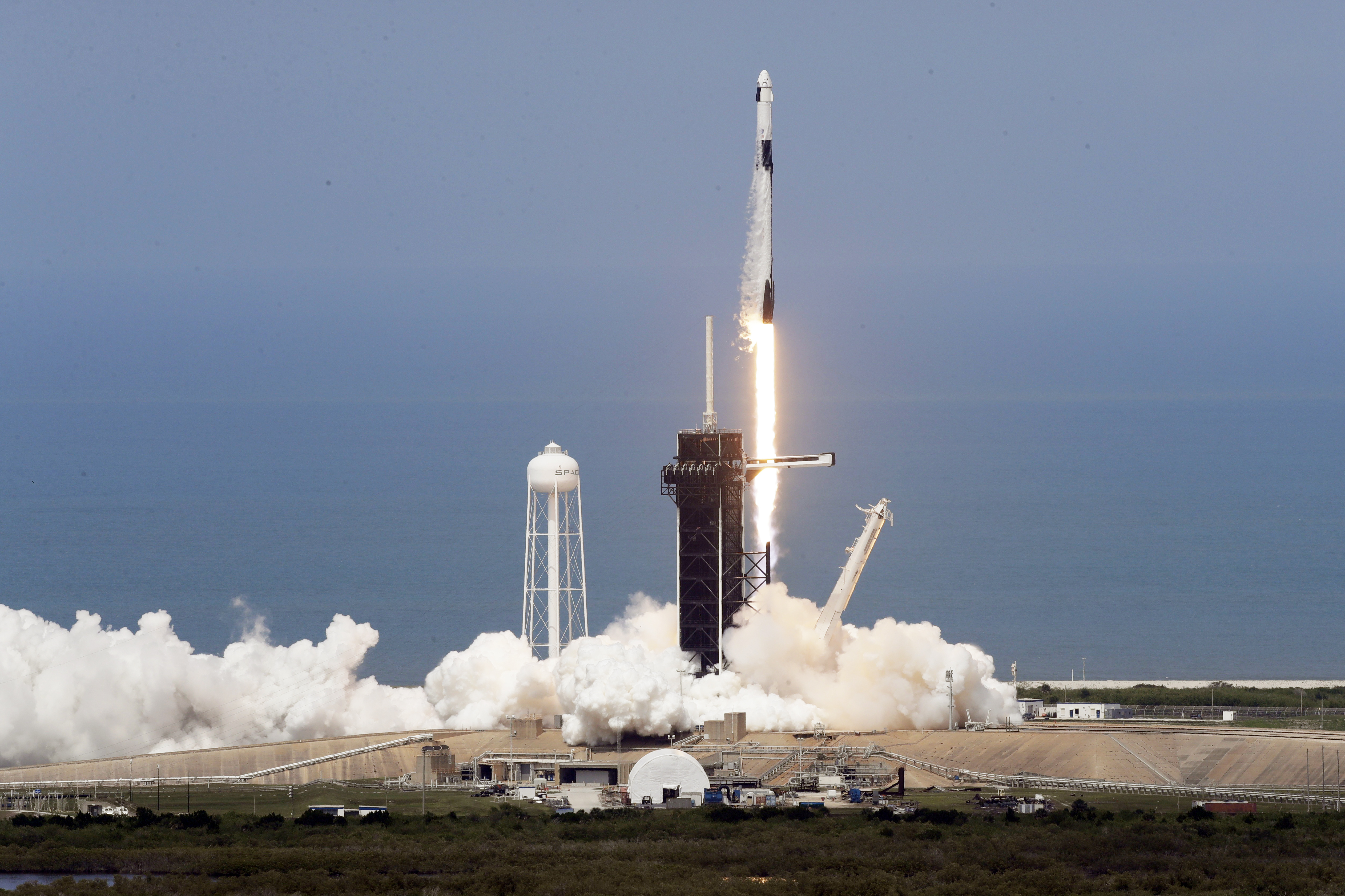 A SpaceX Falcon 9, with NASA astronauts Doug Hurley and Bob Behnken in the Dragon crew capsule, lifts off from Pad 39-A at the Kennedy Space Center in Cape Canaveral, Fla., Saturday, May 30, 2020. The two astronauts are on the SpaceX test flight to the International Space Station. For the first time in nearly a decade, astronauts blasted towards orbit aboard an American rocket from American soil, a first for a private company. (AP Photo/Chris O'Meara)