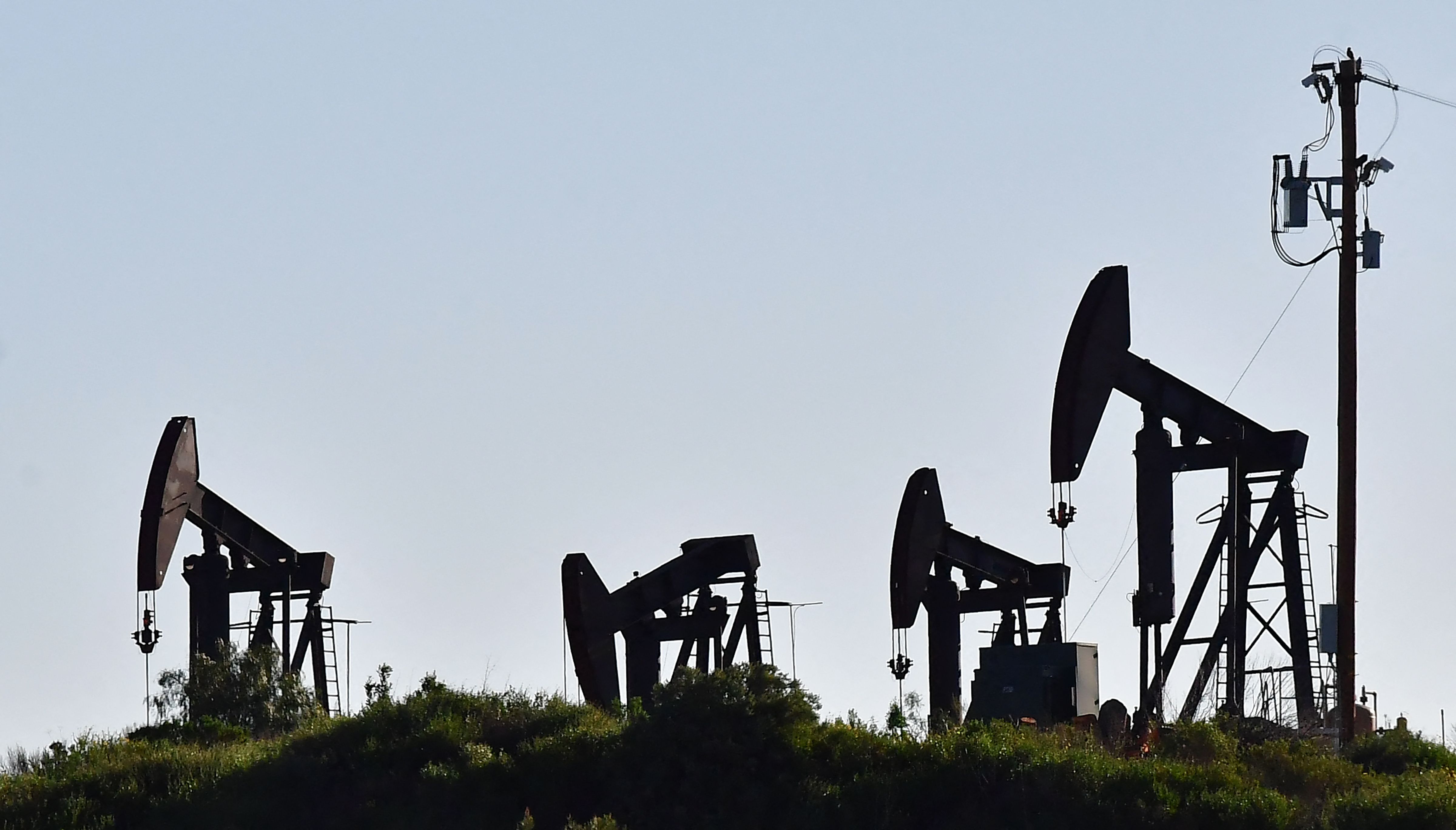Working pumpjacks are seen in the Montebello Oil Field in Montebello, California, on February 23, 2022. - Stock markets mostly rose and oil prices held relatively steady on February 23 as economic sanctions imposed on Moscow over the Russia-Ukraine crisis were deemed less harsh than expected. Brent crude stood at $96.73 per barrel, having soared to a seven-year high of $99.50 on February 22 on fears of disruptions to key Russian oil supplies. (Photo by Frederic J. BROWN / AFP)