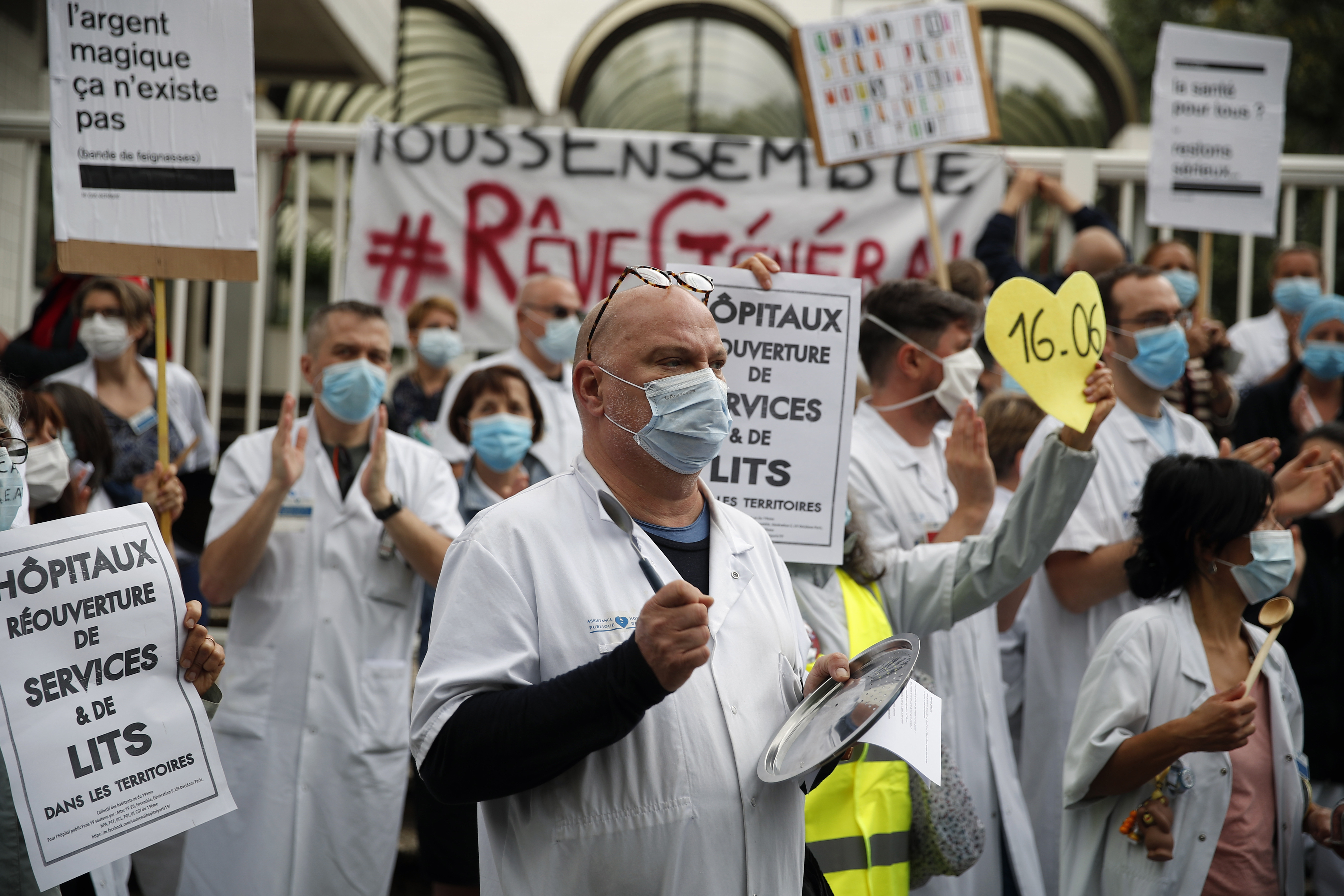 Medical staff demonstrate at the Robert Debre hospital in Paris, Thursday, June 4, 2020. French nurses and doctors demand better pay and a rethink of a once-renowned public health system that found itself quickly overwhelmed by tens of thousands of virus patients. (AP Photo/Francois Mori)