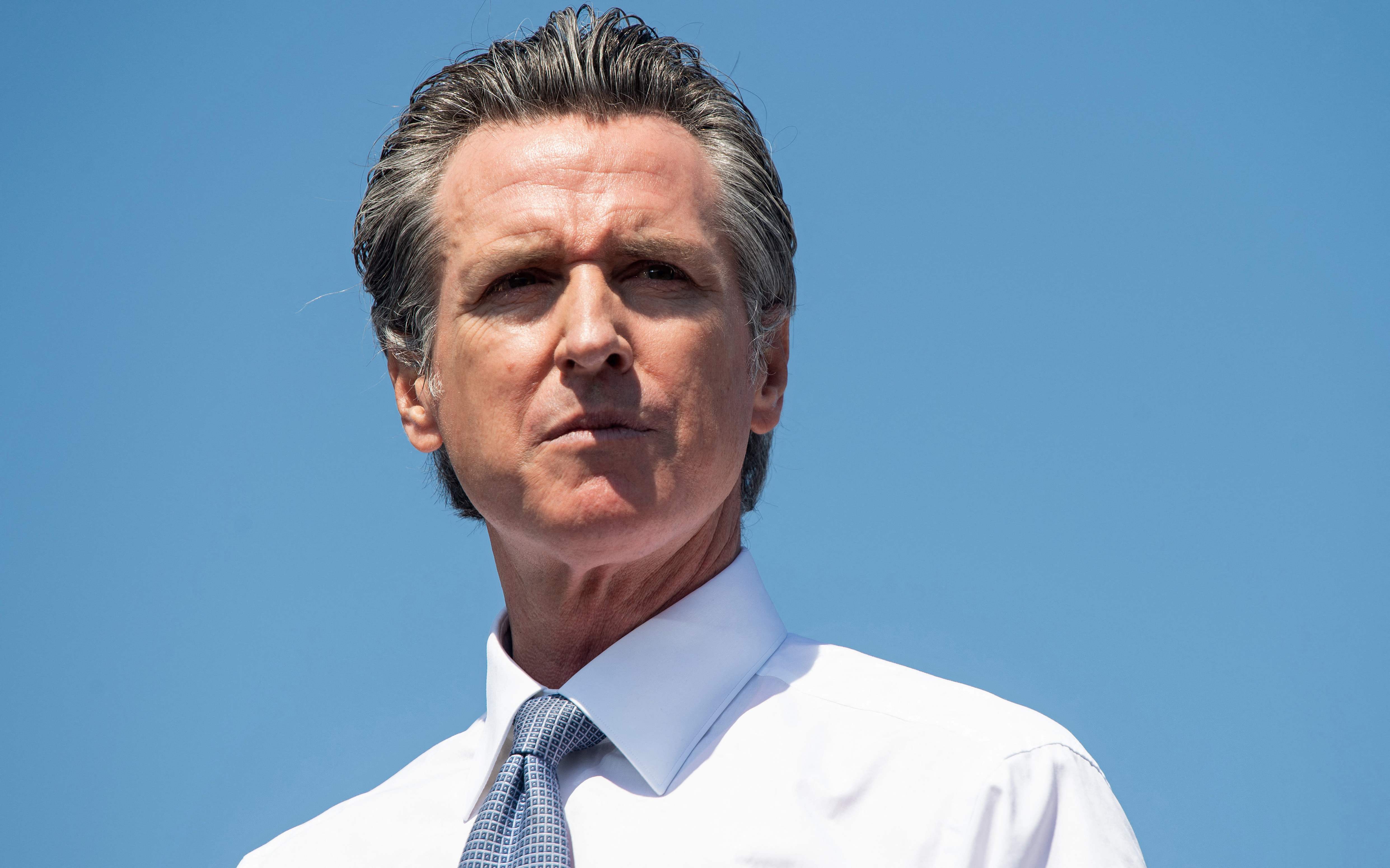 (FILES) In this file photo taken on September 08, 2021 California Governor Gavin Newsom looks on as he speaks during a campaign rally against his recall election with US Vice President Kamala Harris at the IBEW-NECA Joint Apprenticeship Training Center in San Leandro, California. - It's a $280 million taxpayer-funded election that most Californians don't want, and which could see a candidate with only a handful of votes take the reins of the world's fifth-largest economy.California is voting on recalling Gavin Newsom, a Democrat who won the deep-blue US state's governorship by a landslide in 2018, and whose term expires next year anyway. (Photo by SAUL LOEB / AFP)