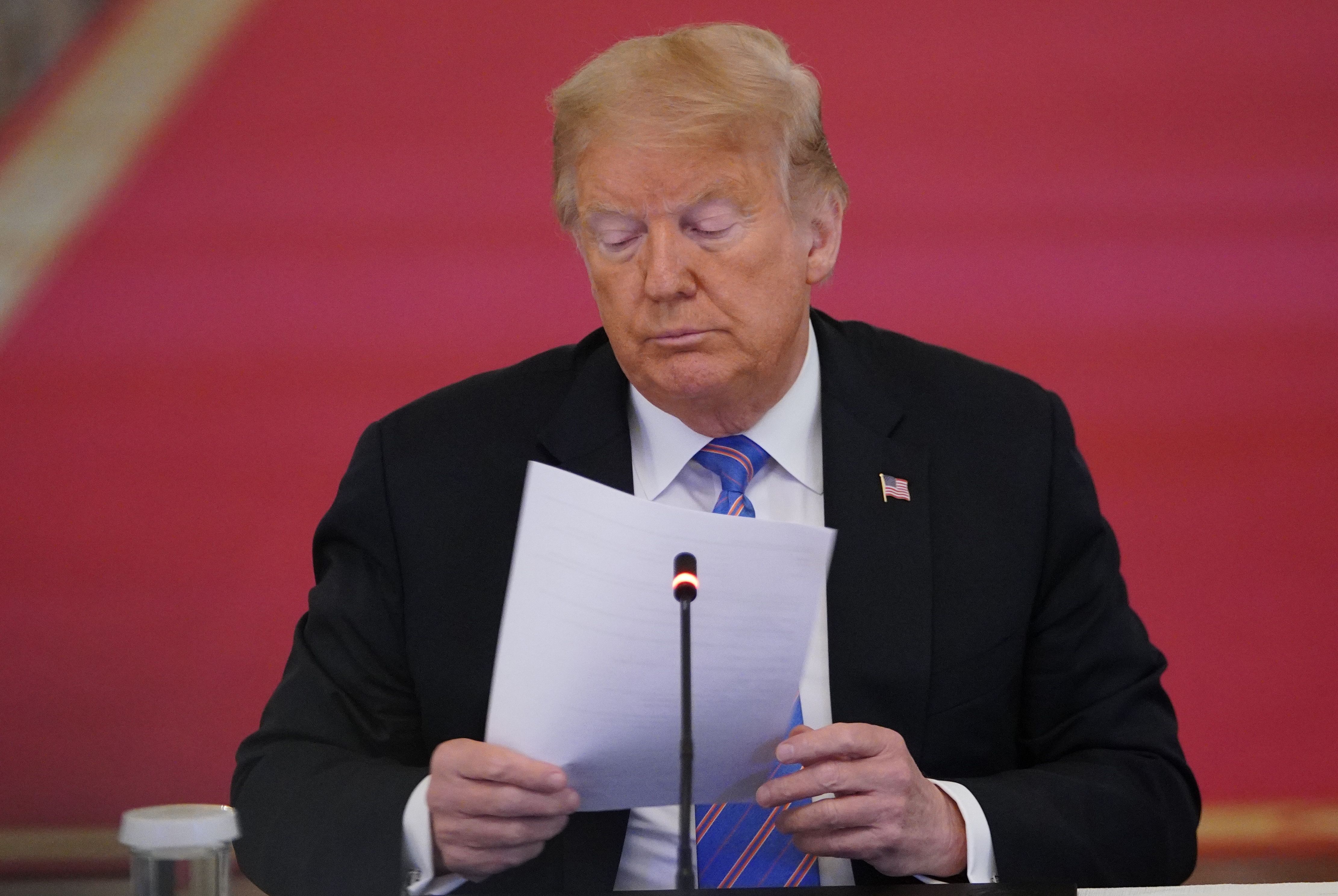 (FILES) In this file photo taken on June 26, 2020 US President Donald Trump looks on during an American Workforce Policy Advisory Board Meeting in the East Room of the White House in Washington, DC. - US President Donald Trump denied June 28, 2020 being briefed on intelligence that reportedly showed Russia had offered bounties to Taliban-linked militants for killing US soldiers in Afghanistan. (Photo by MANDEL NGAN / AFP)