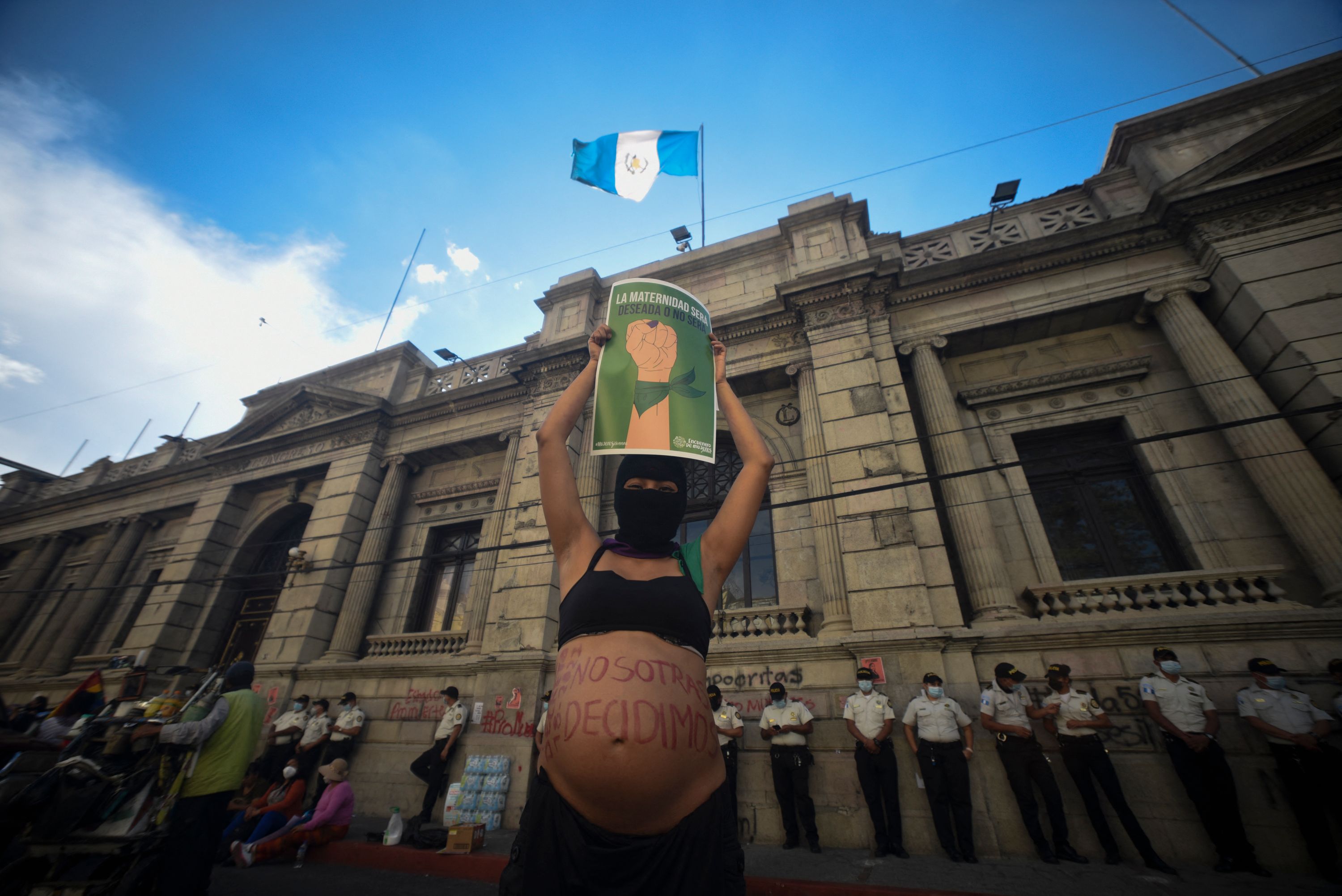 TOPSHOT - People protest for abortion and LGBTQ rights outside of the Guatemalan Congress in Guatemala City on March 15, 2022. - The Guatemalan Congress, controlled by conservative officialists, closed Tuesday a controversial law that contemplated tightening abortion penalties and prohibiting homosexual marriage, in the midst of complaints from human rights agencies and at the request of the president himself. (Photo by Orlando ESTRADA / AFP)